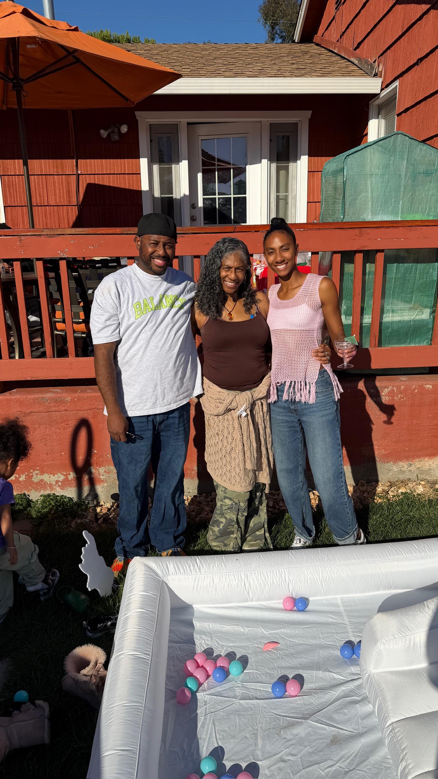 A group of people standing in front of a house