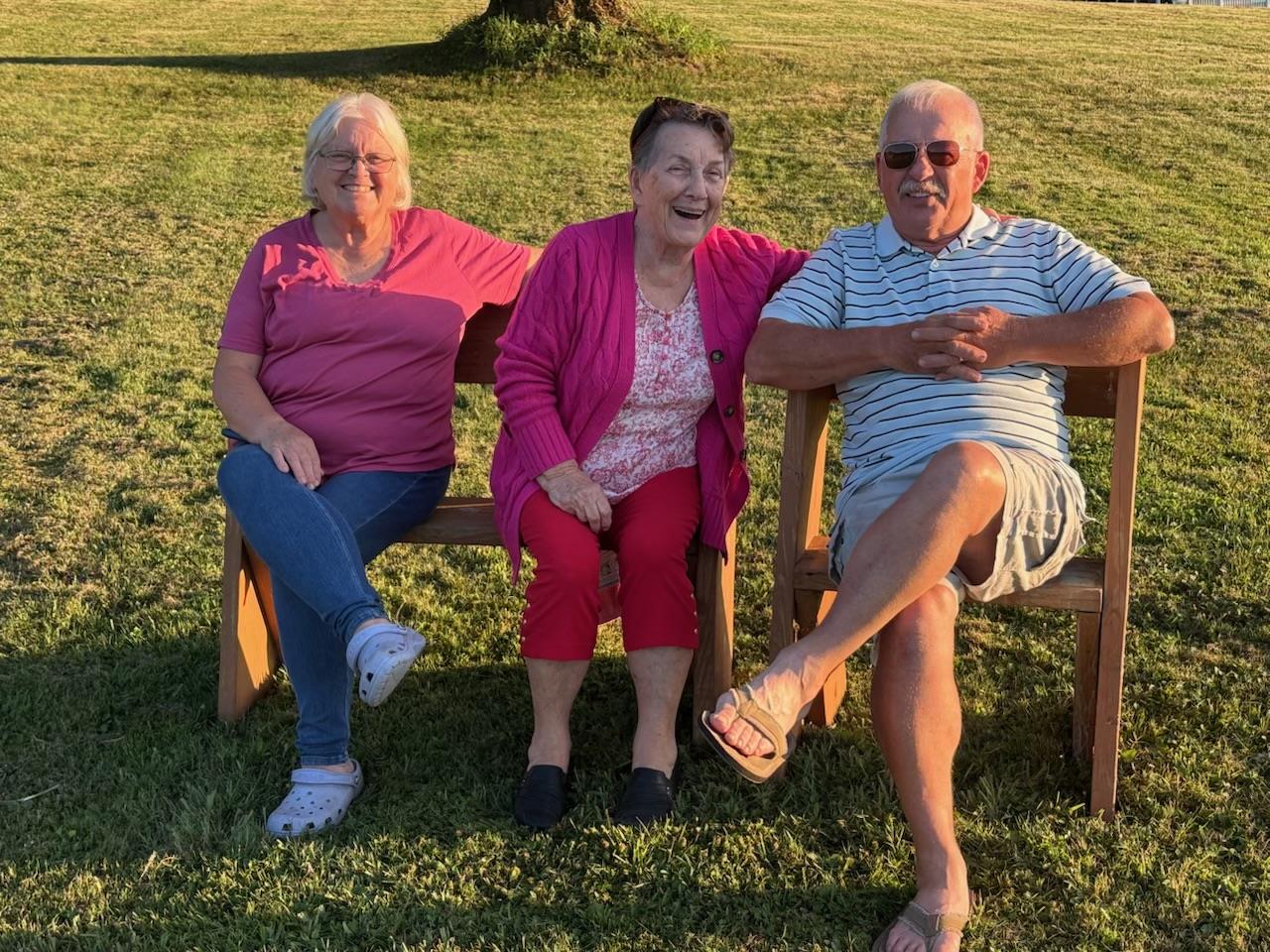 A group of people sitting on a bench