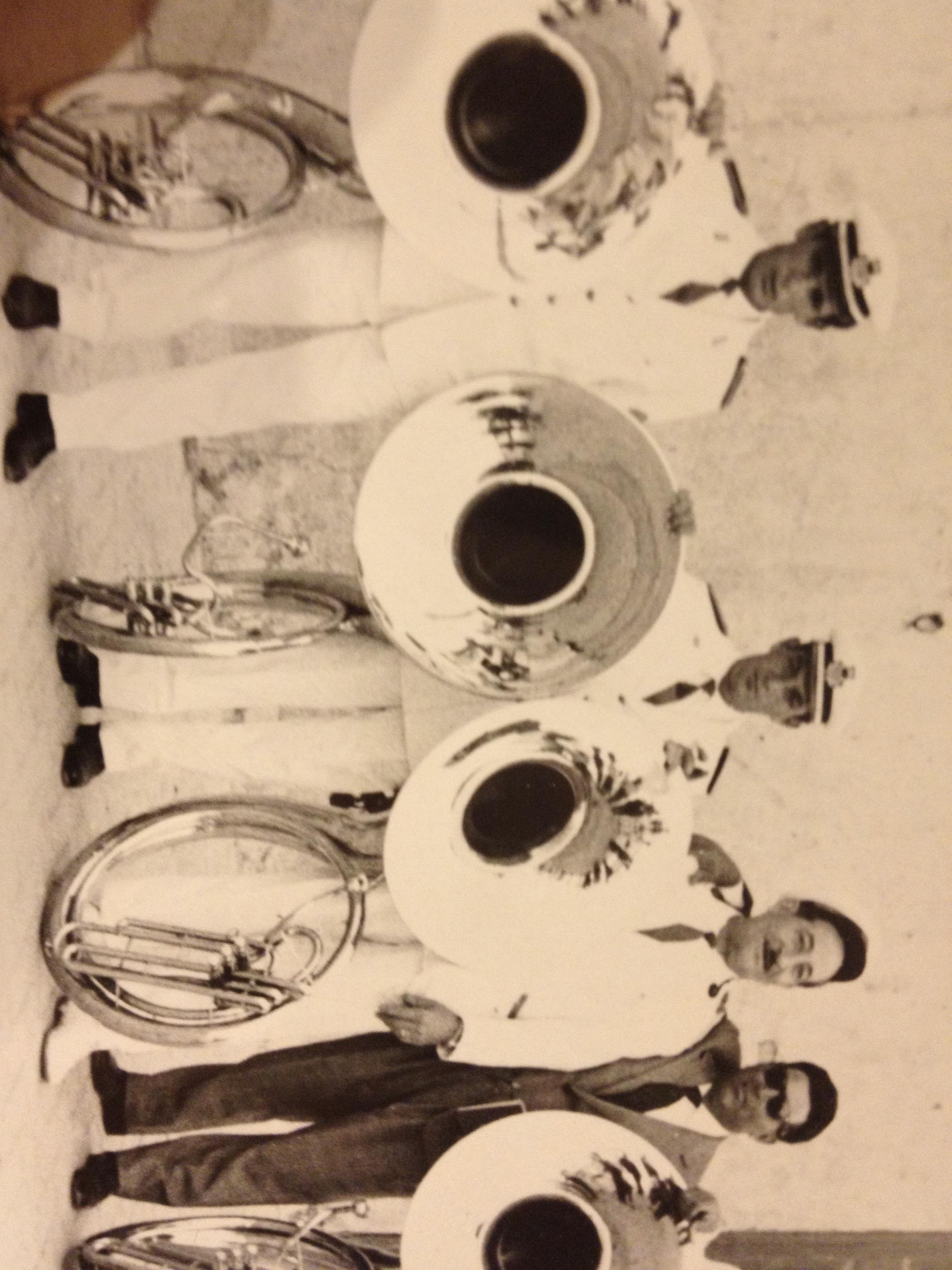 A group of men holding instruments