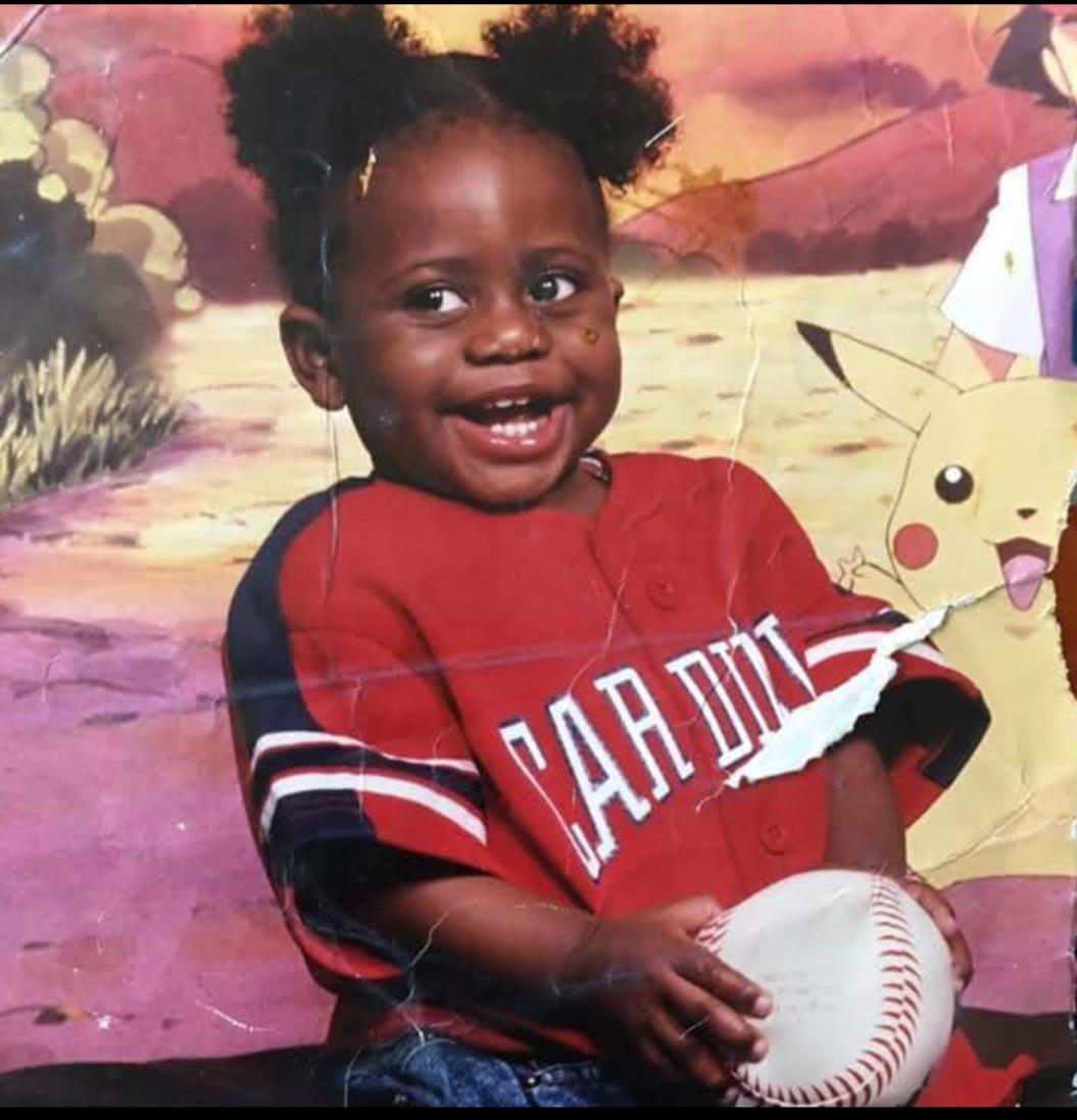 A child holding a baseball