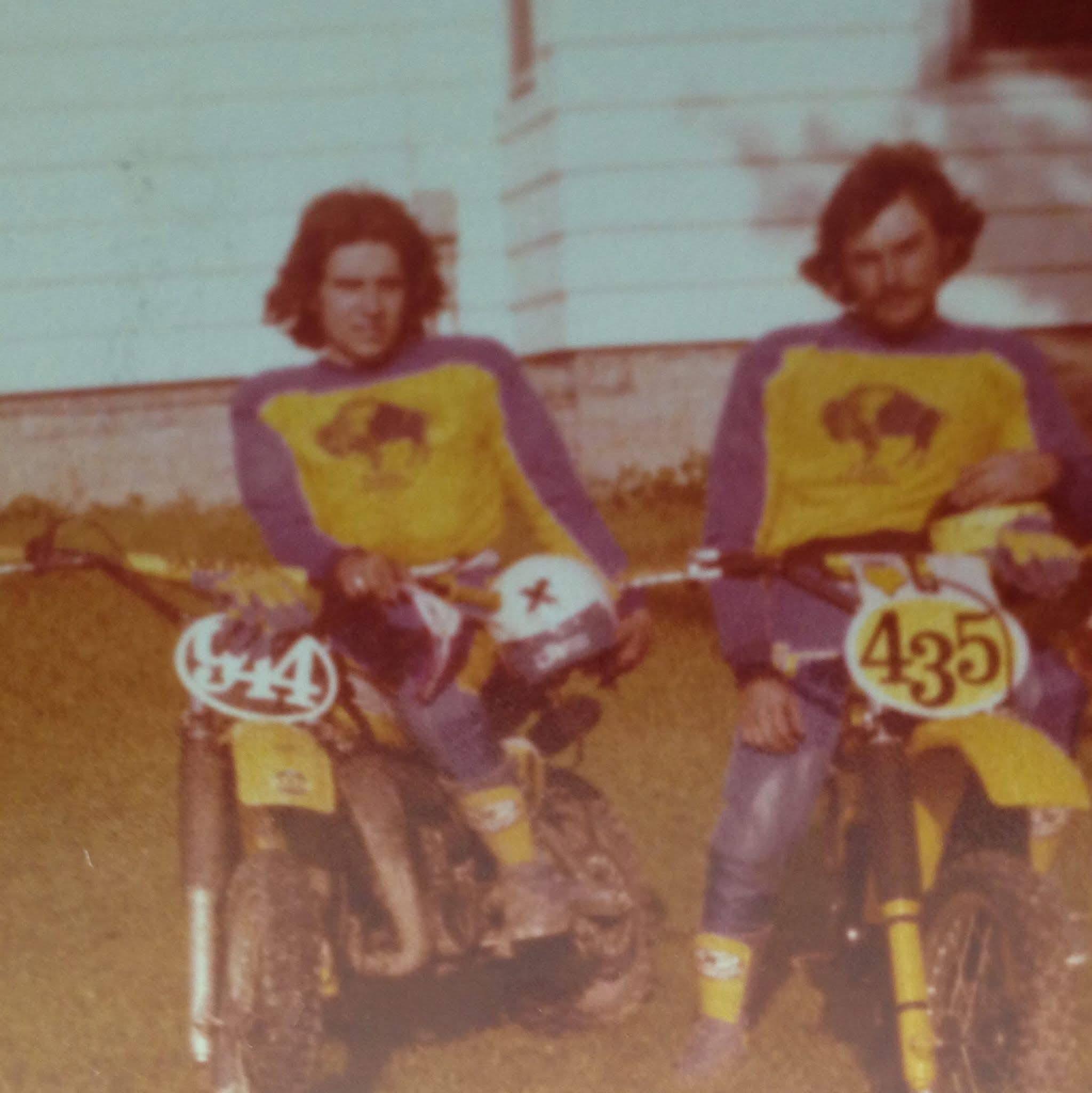 Two men sitting on dirt bikes