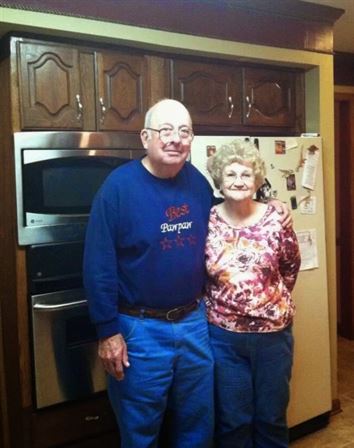 A man and woman standing in a kitchen