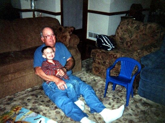 A man and child sitting on the floor