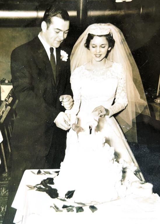 A man and woman cutting a cake