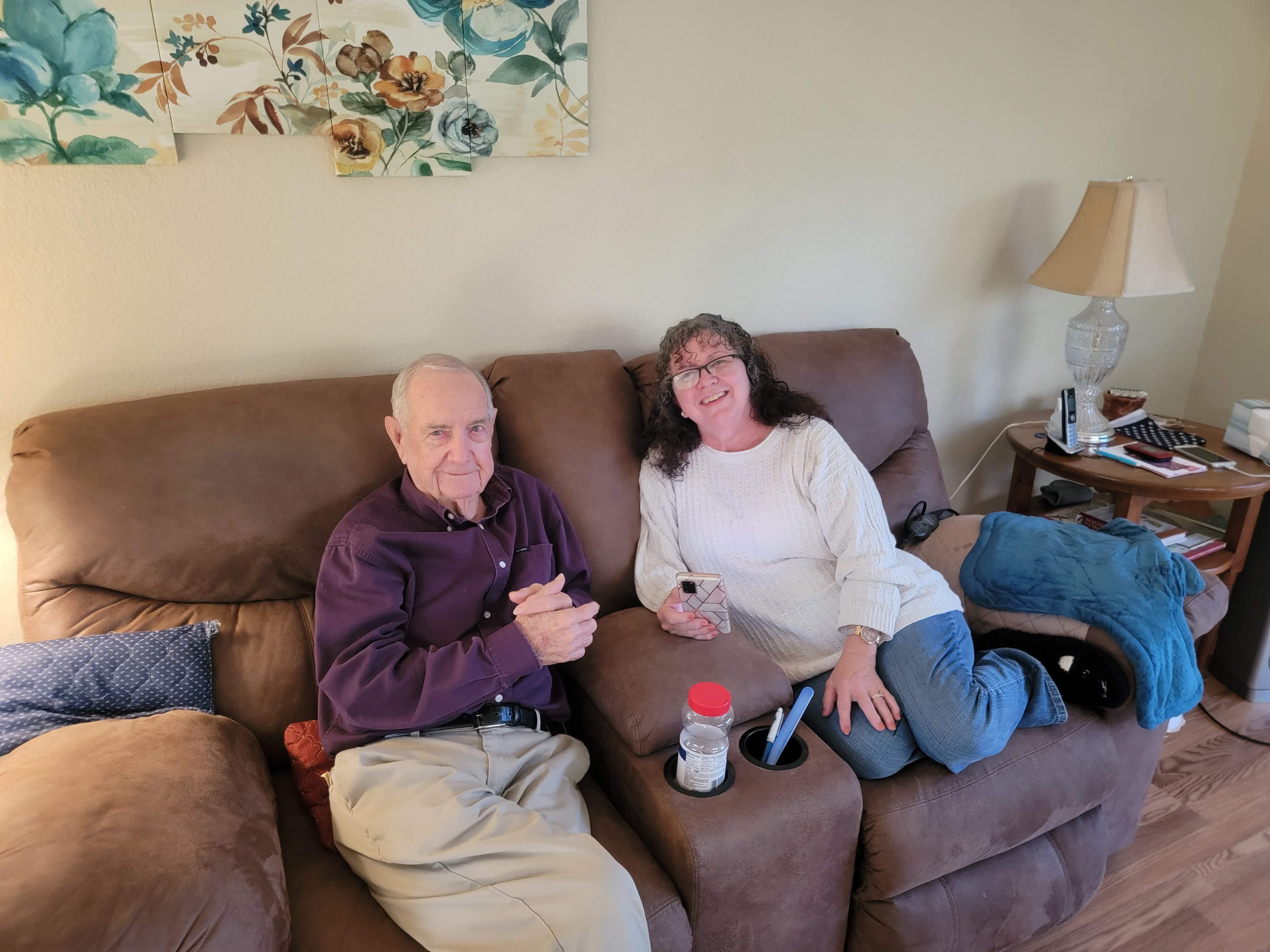 A man and woman sitting on a couch