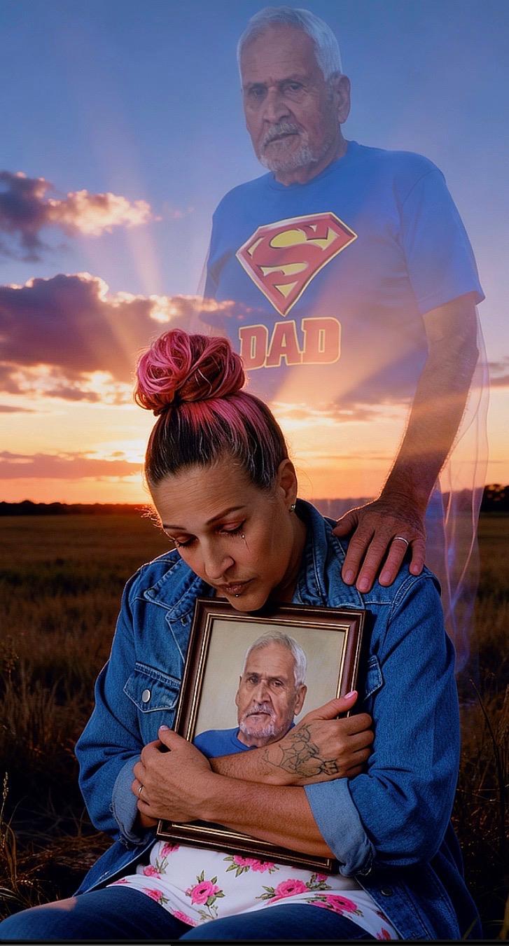 A woman holding a picture of a man