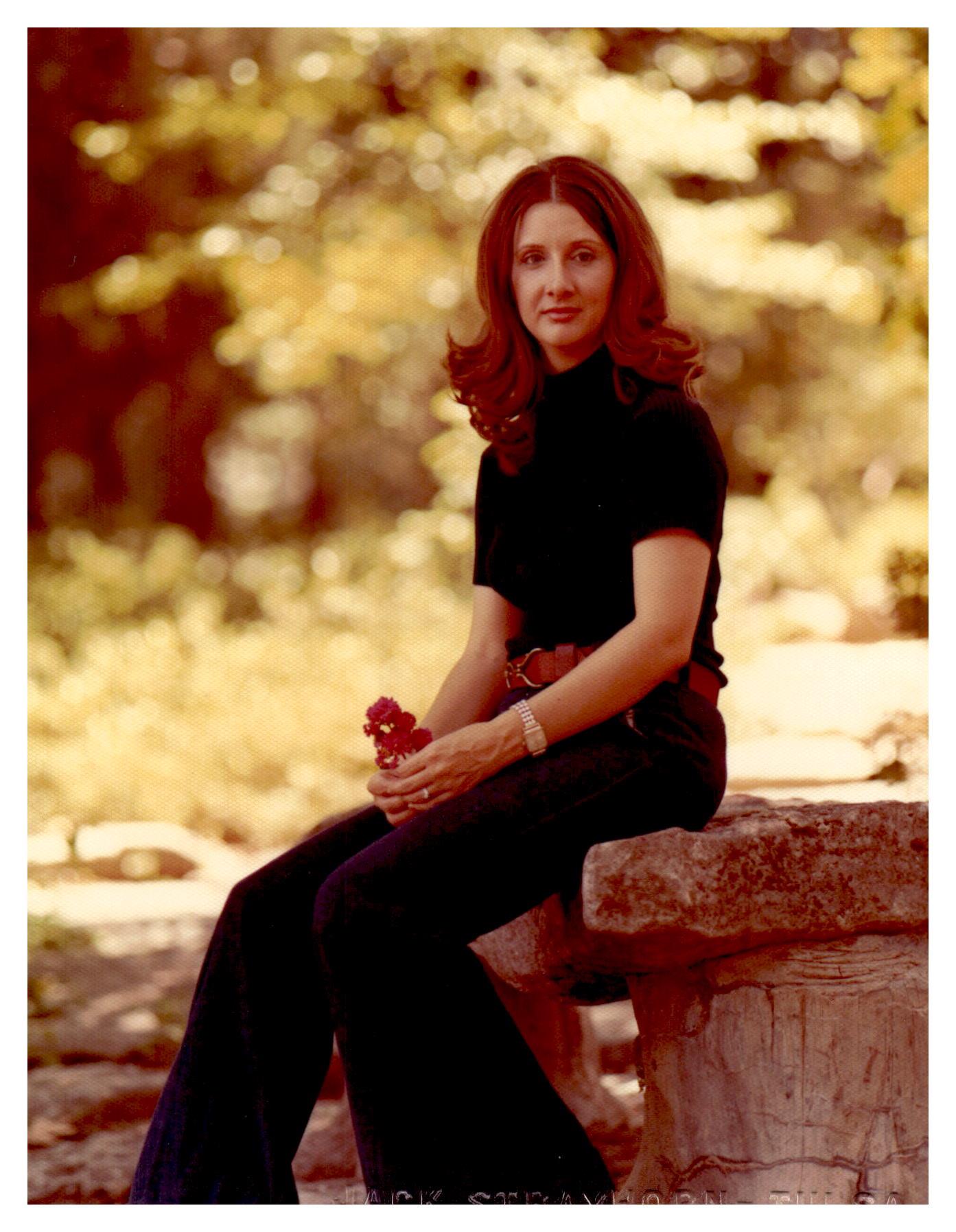 A woman sitting on a stone bench