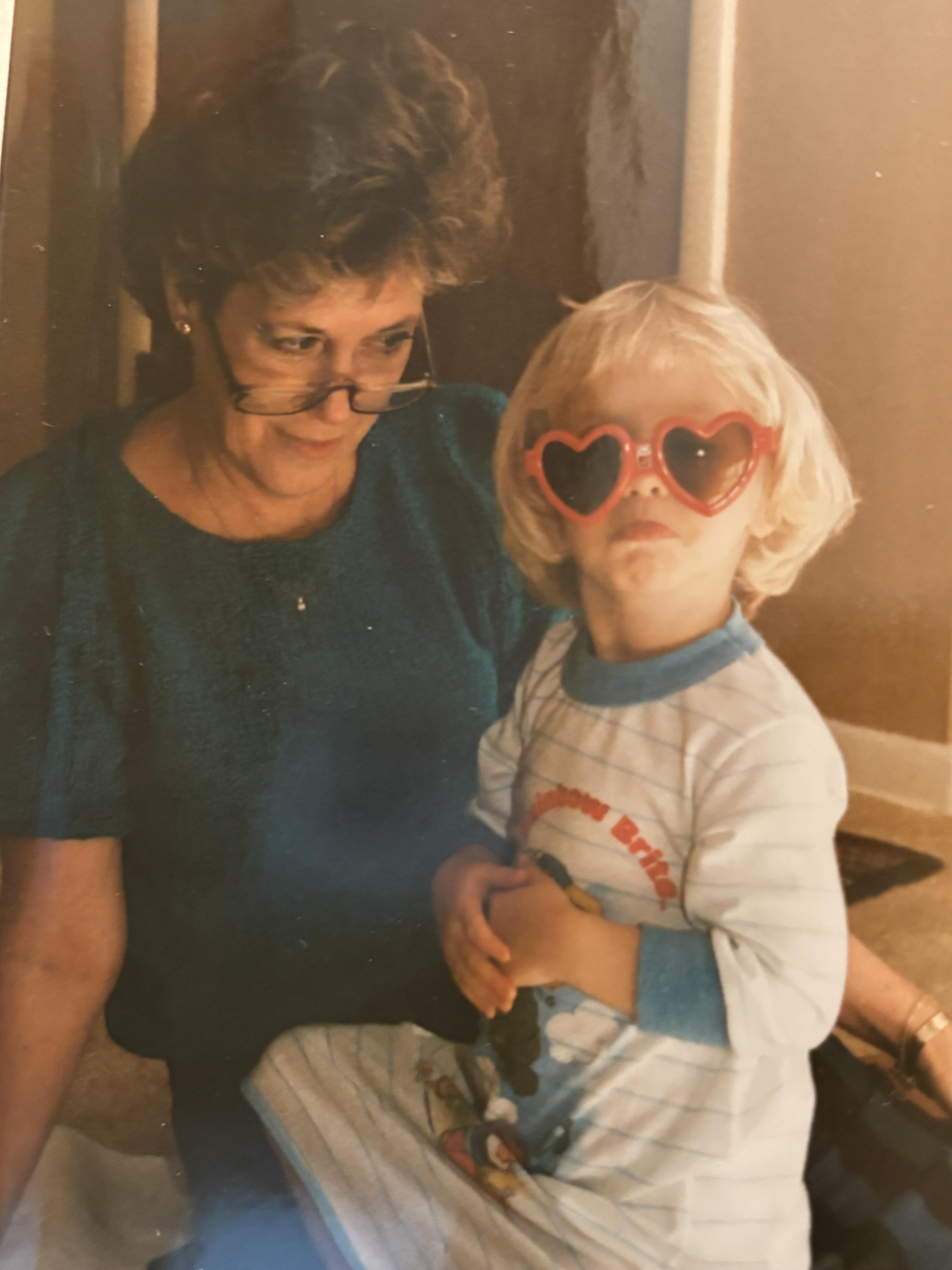 A woman and child wearing heart shaped sunglasses