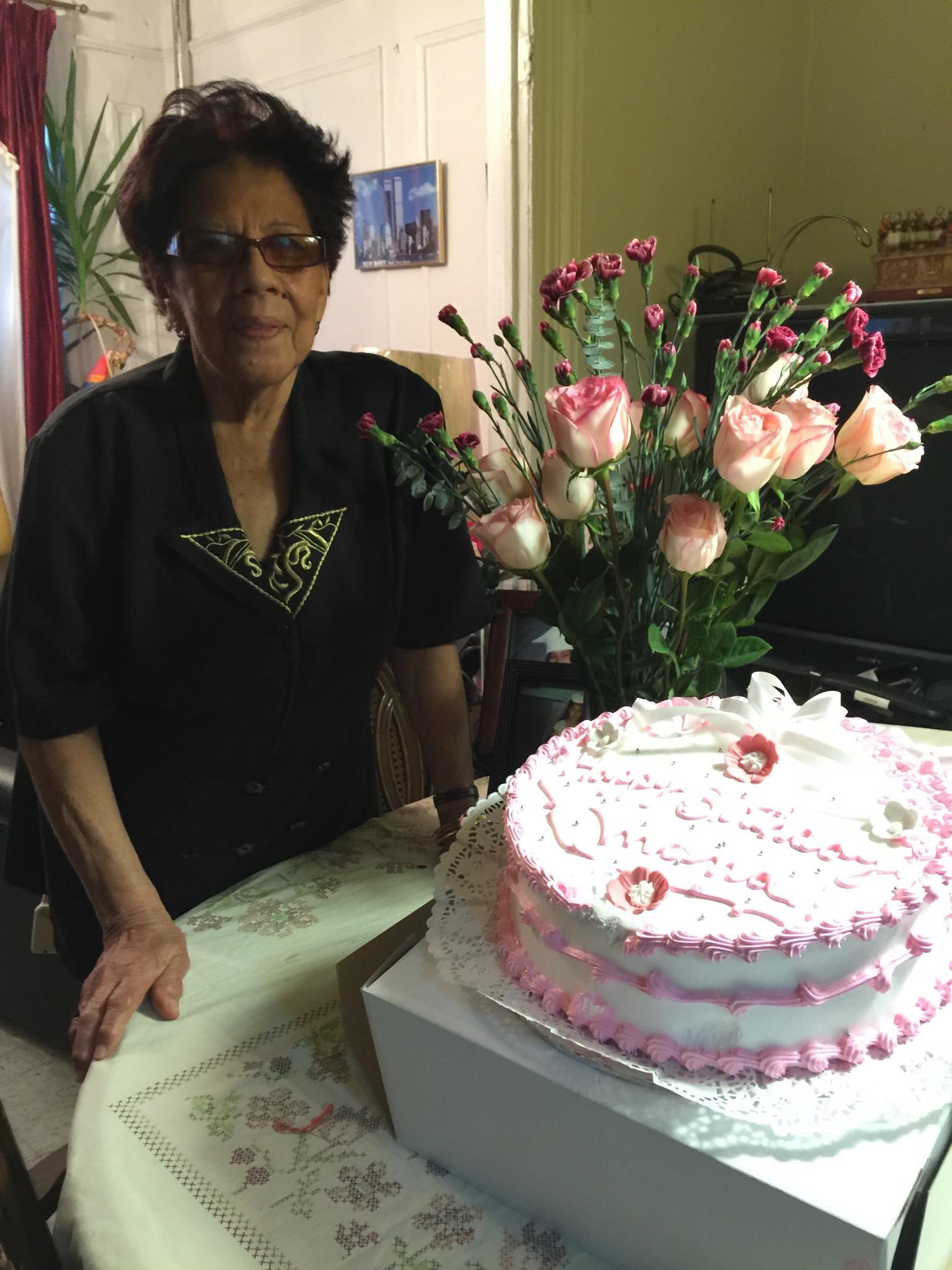 A woman standing in front of a cake