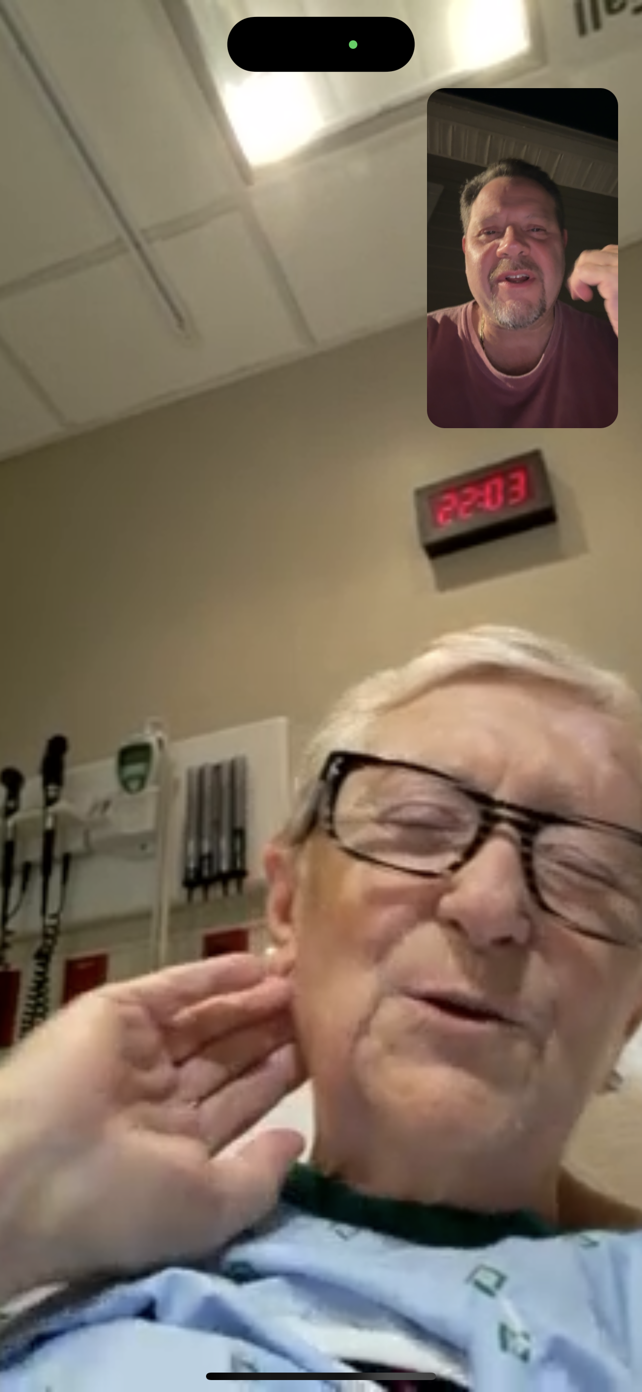 A man with glasses and a clock