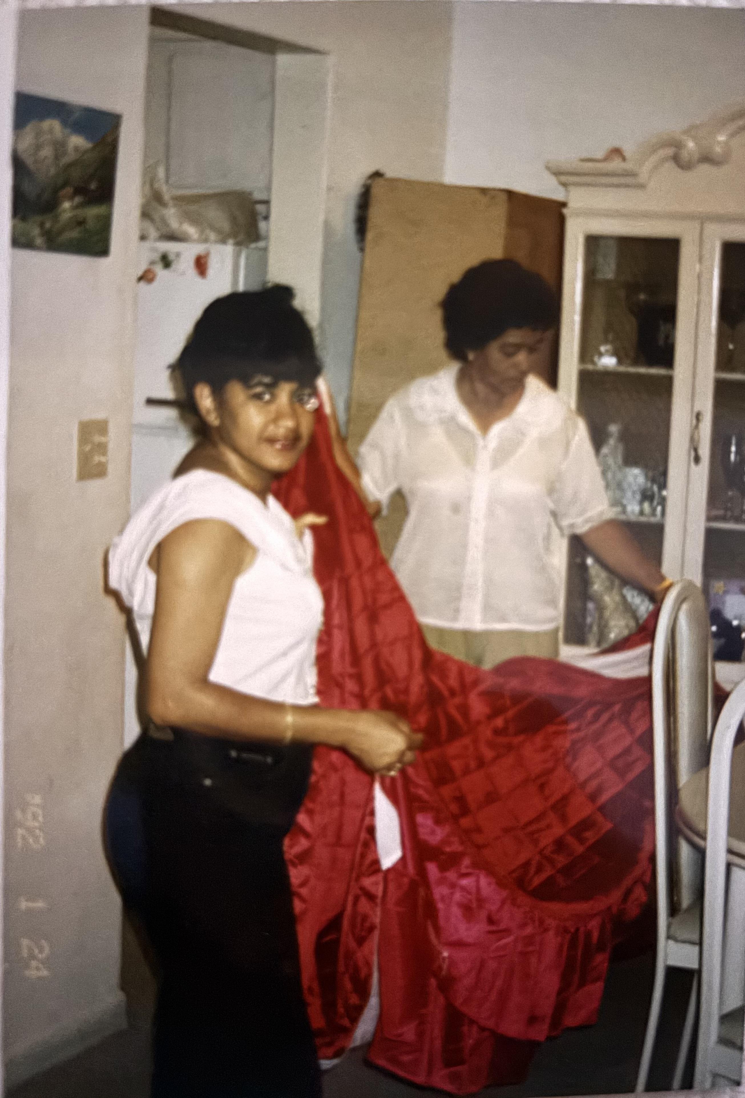 A woman holding a red blanket