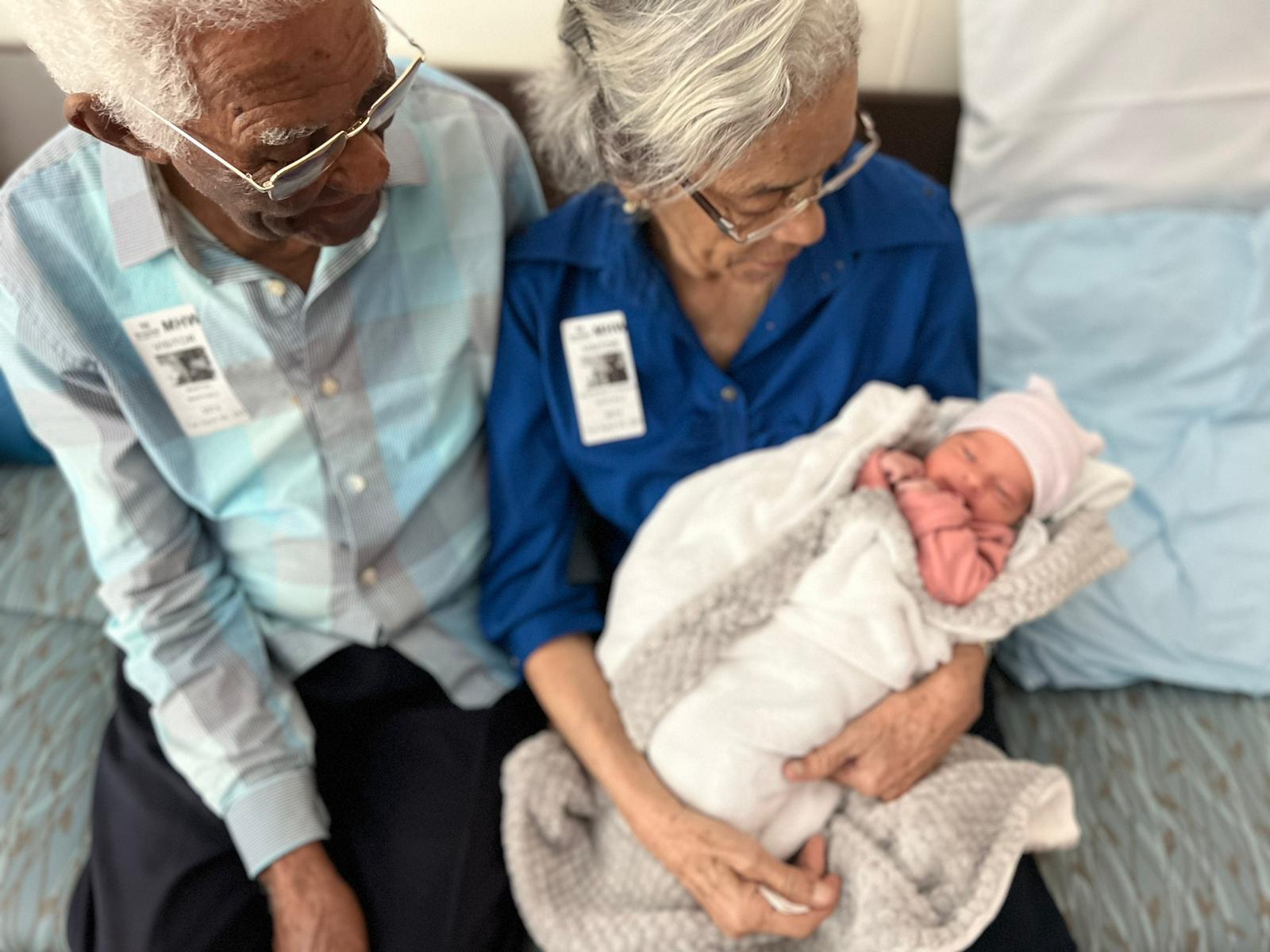 A man and woman holding a baby
