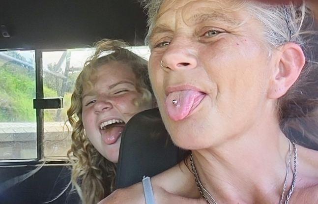Two women sticking their tongue out