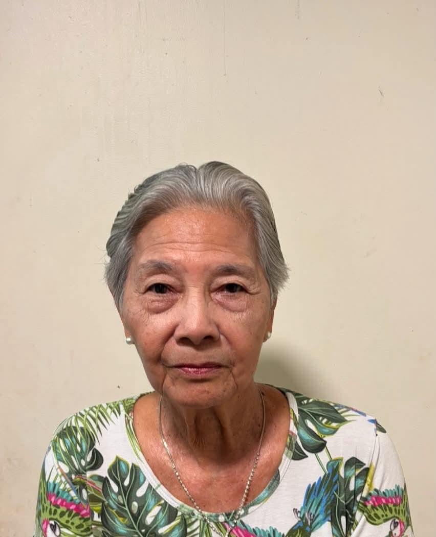 A woman with grey hair and a floral shirt