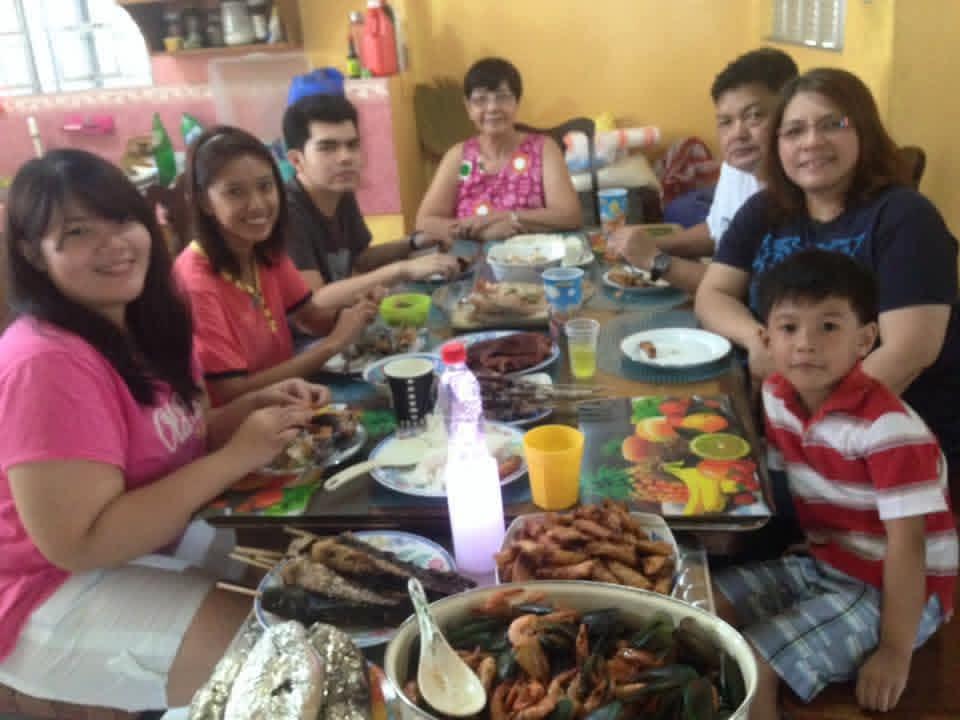 A group of people sitting around a table with food