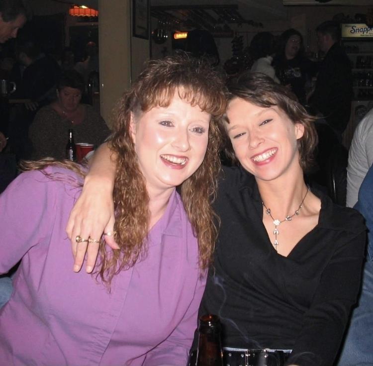 A couple of women smiling at the camera