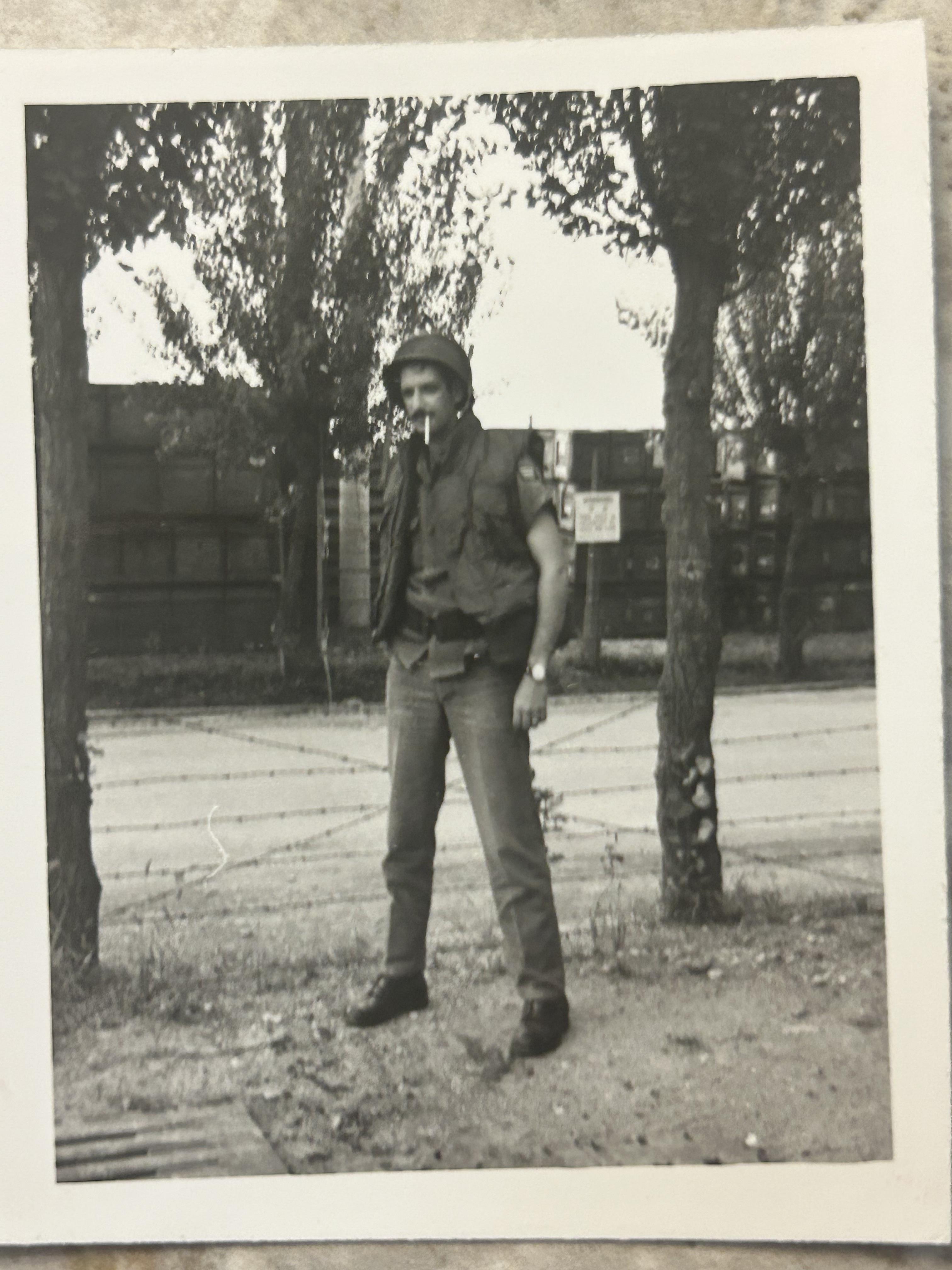 A man in a military uniform smoking a cigarette