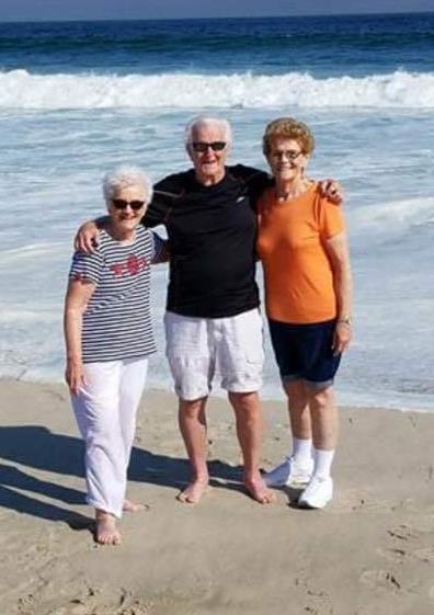 A group of people standing on a beach