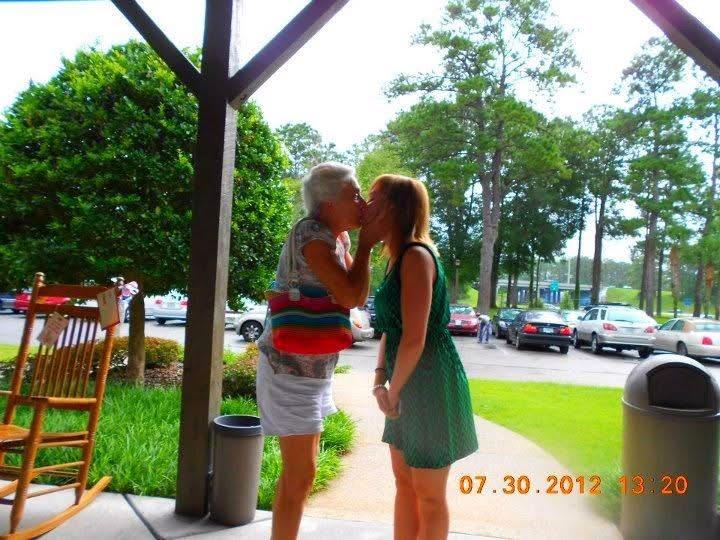 Two women kissing on the porch