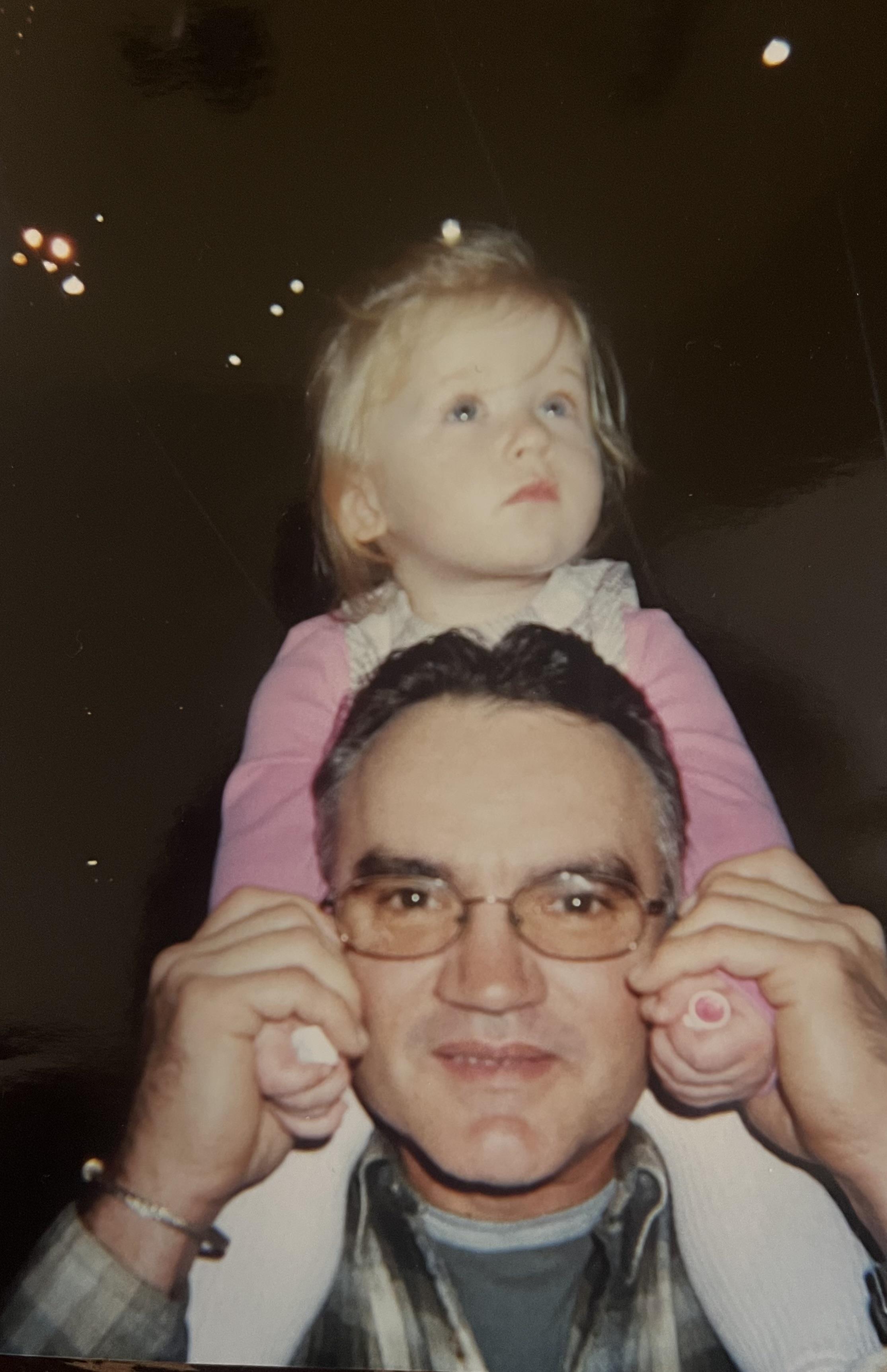 A man holding a child on his shoulders