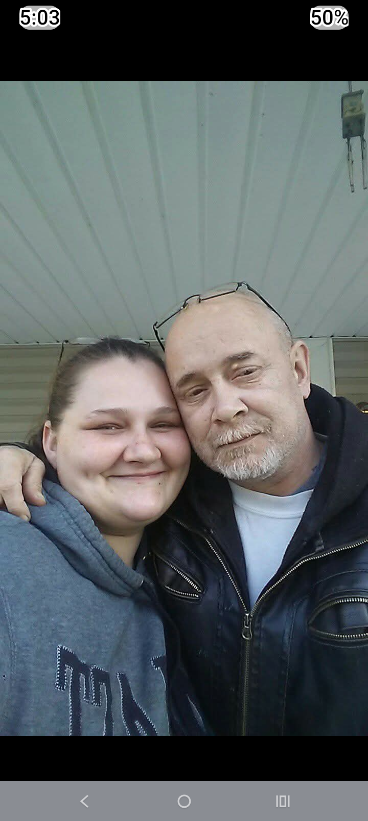 A man and woman posing for a picture