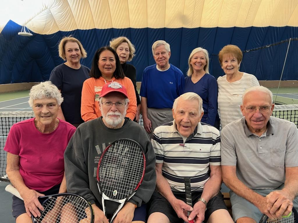 A group of older people posing for a photo