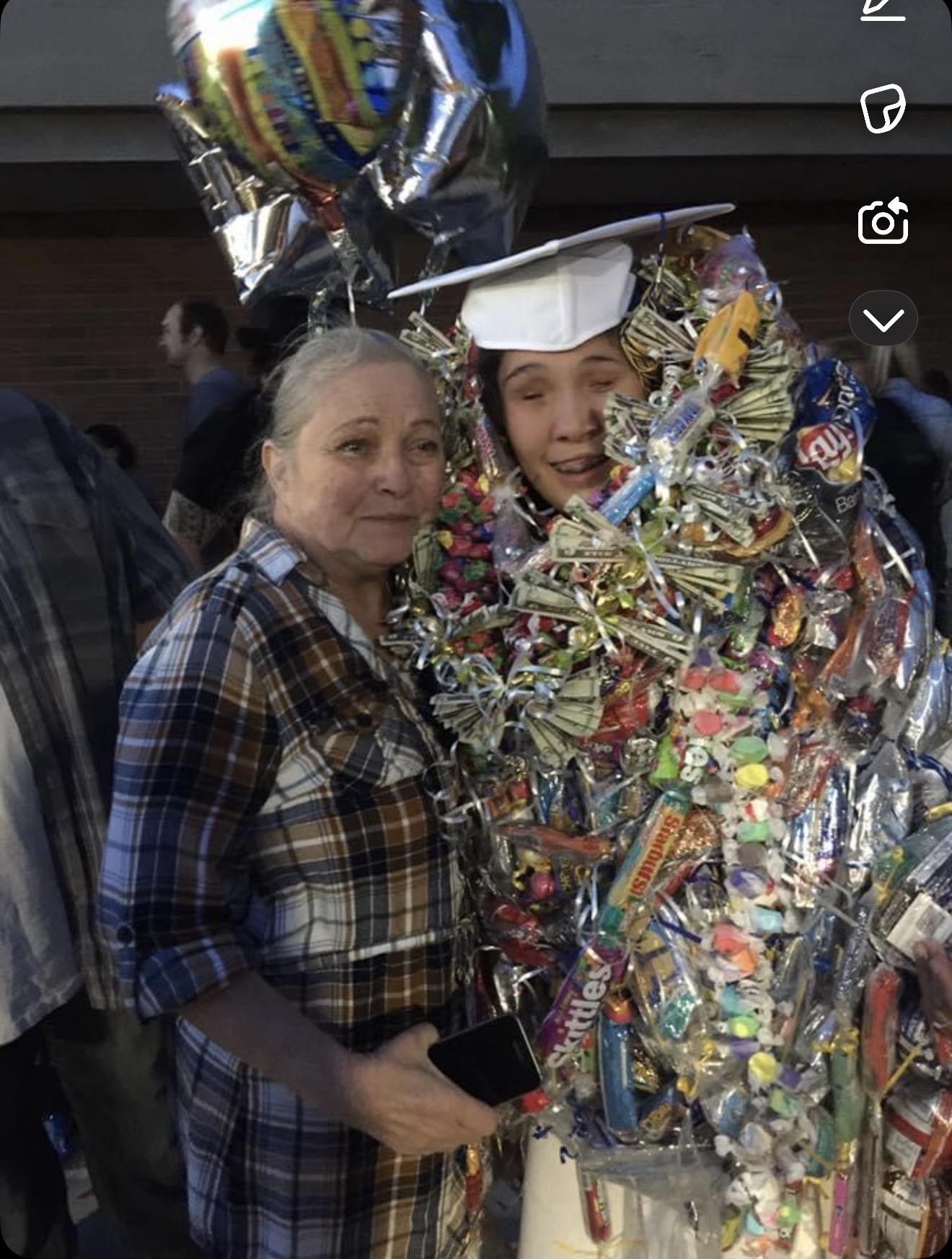 A woman standing next to a person in a garment