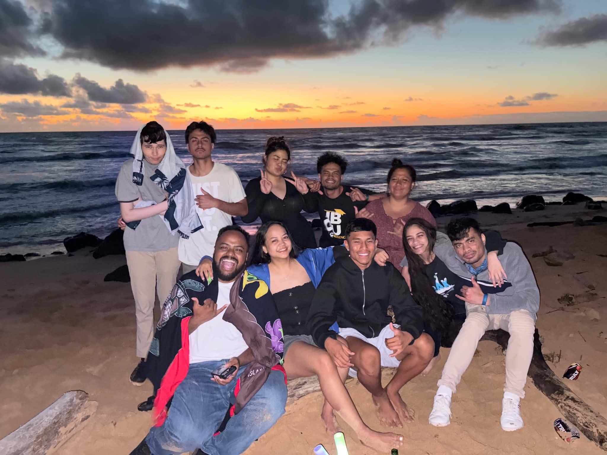 A group of people posing for a photo on a beach