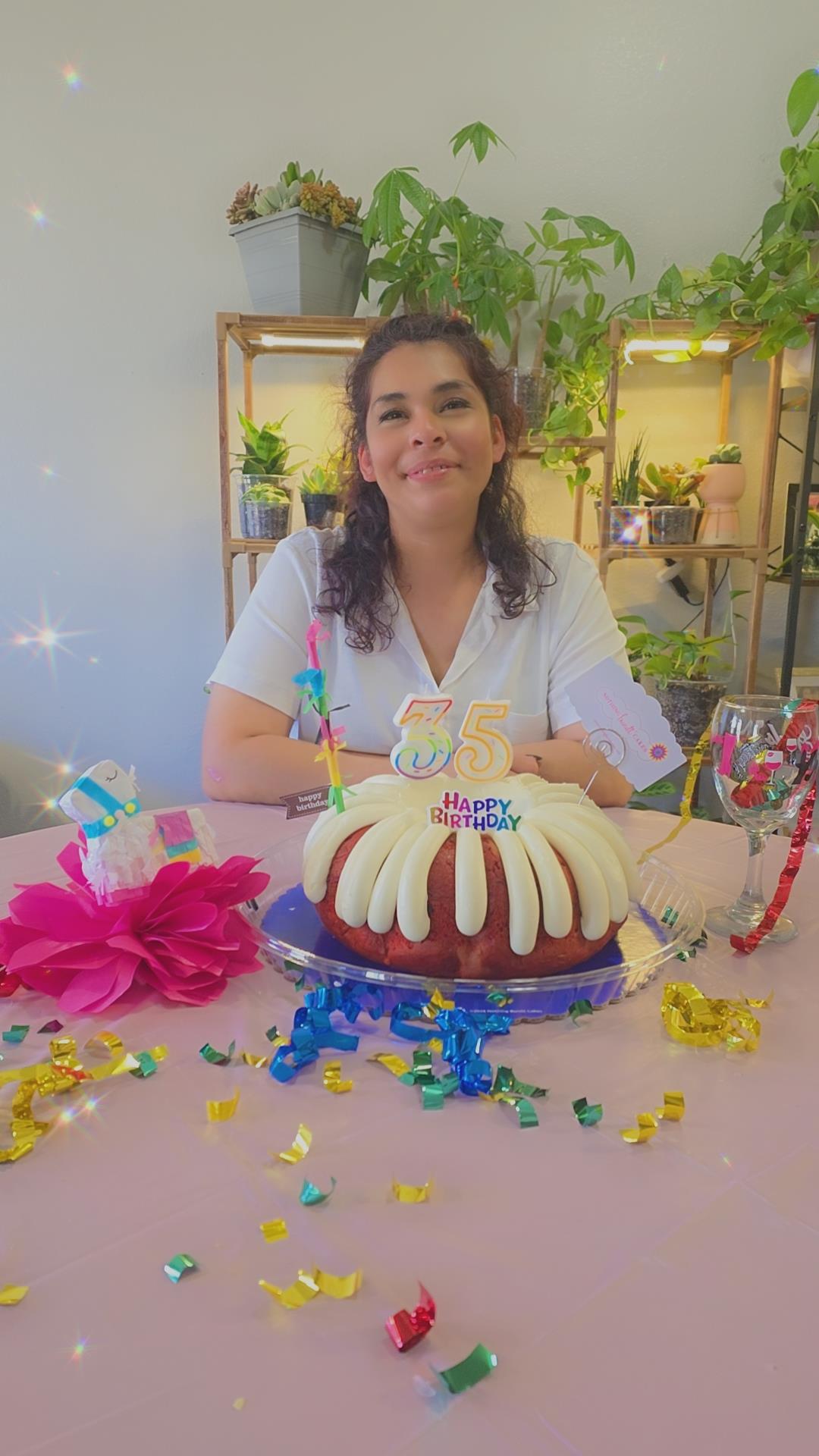 A woman sitting at a table with a cake