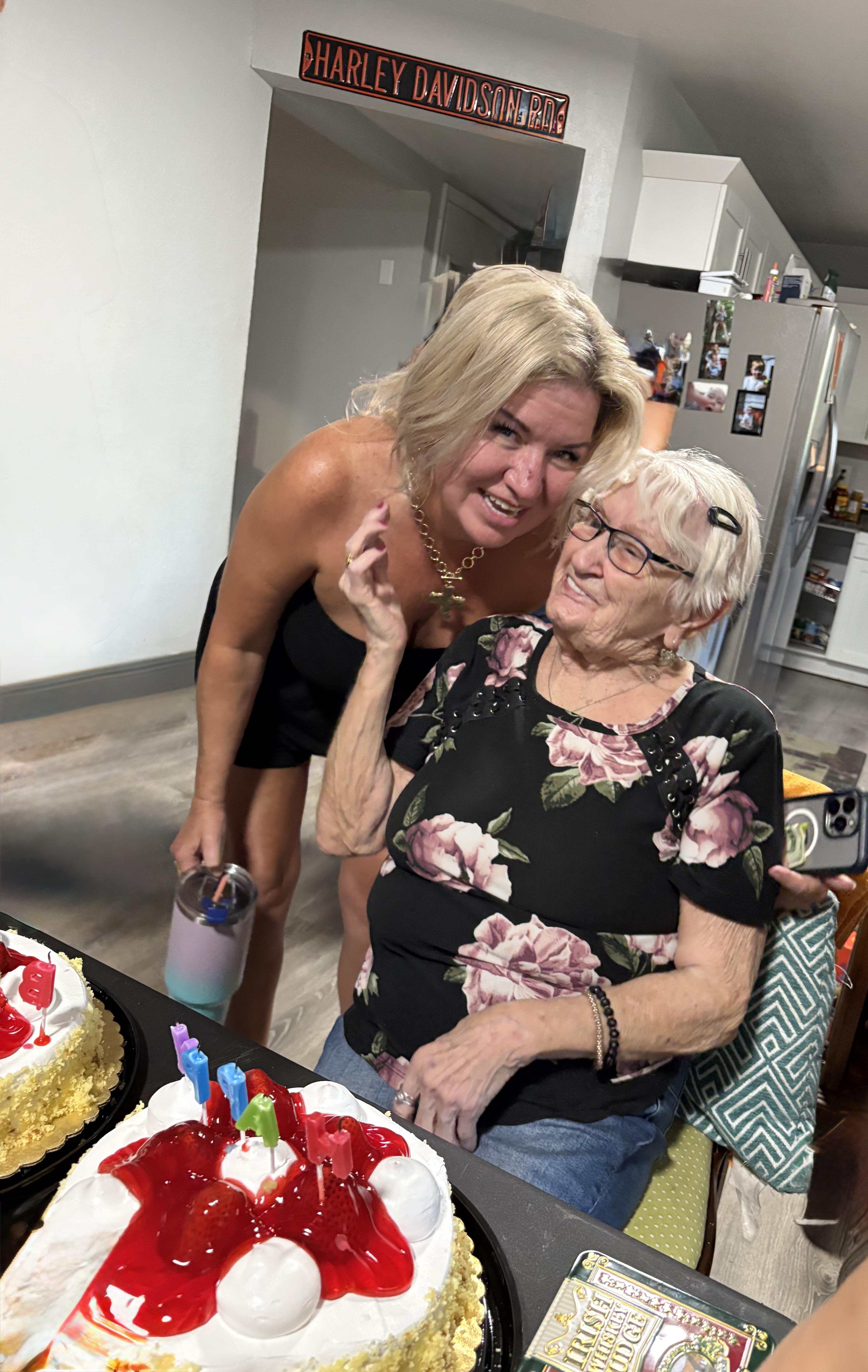 A woman standing next to an older woman