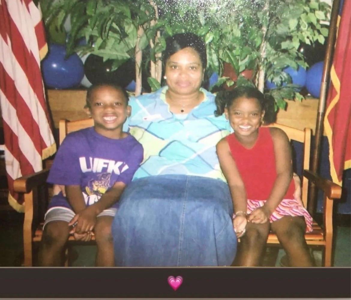 A woman and children sitting in a chair
