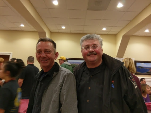 Two men standing together smiling