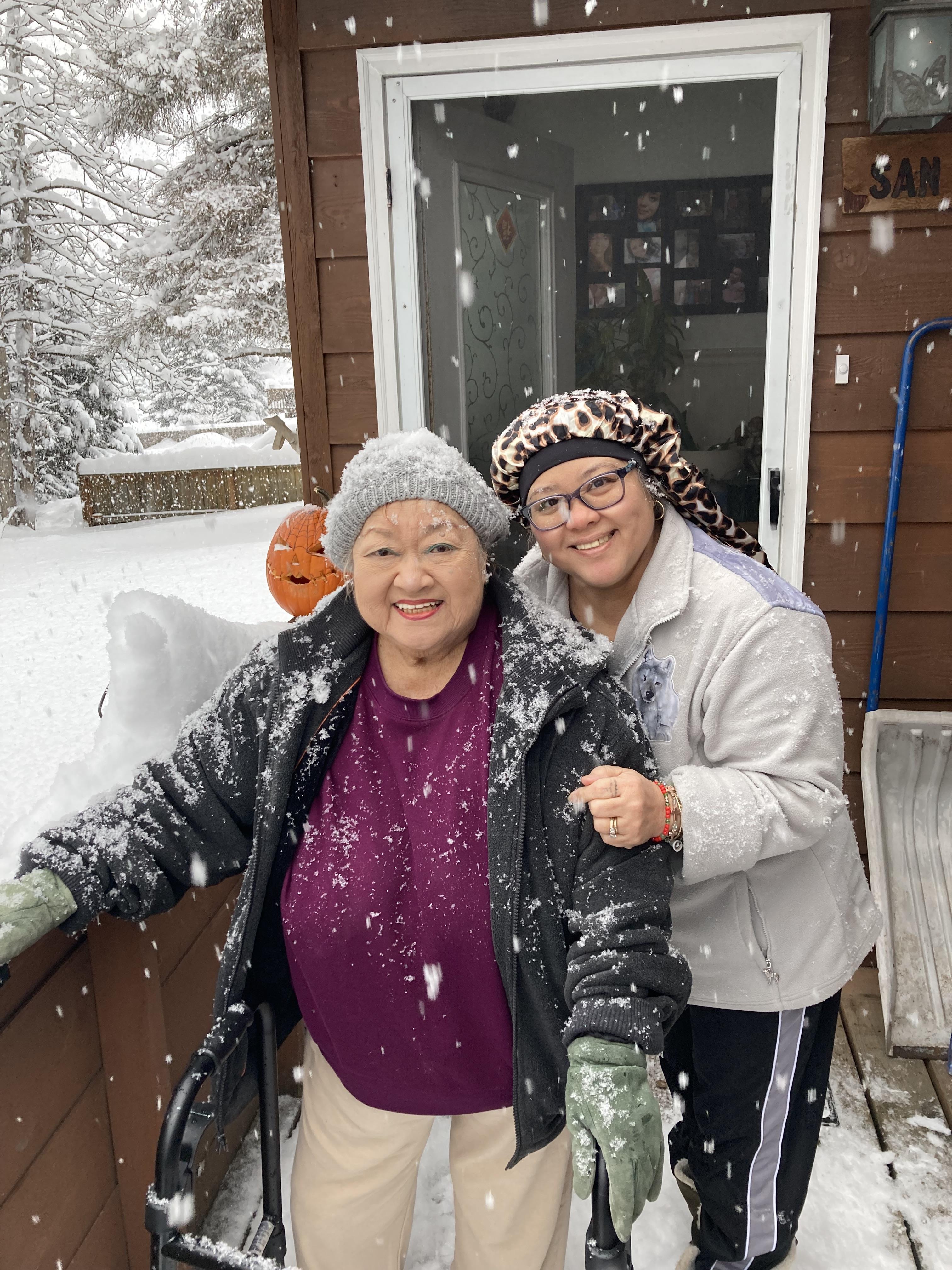 Two women standing in the snow