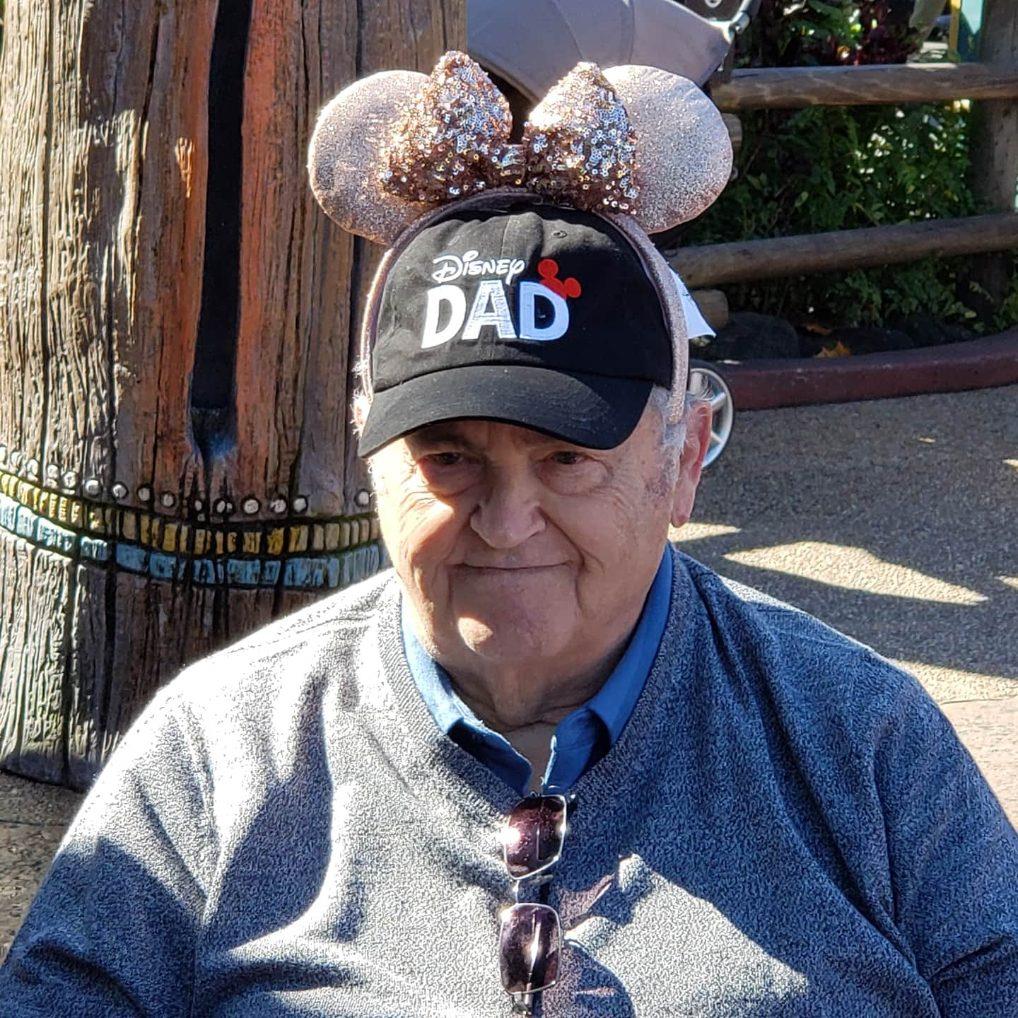 A man wearing a hat with a bow on his head