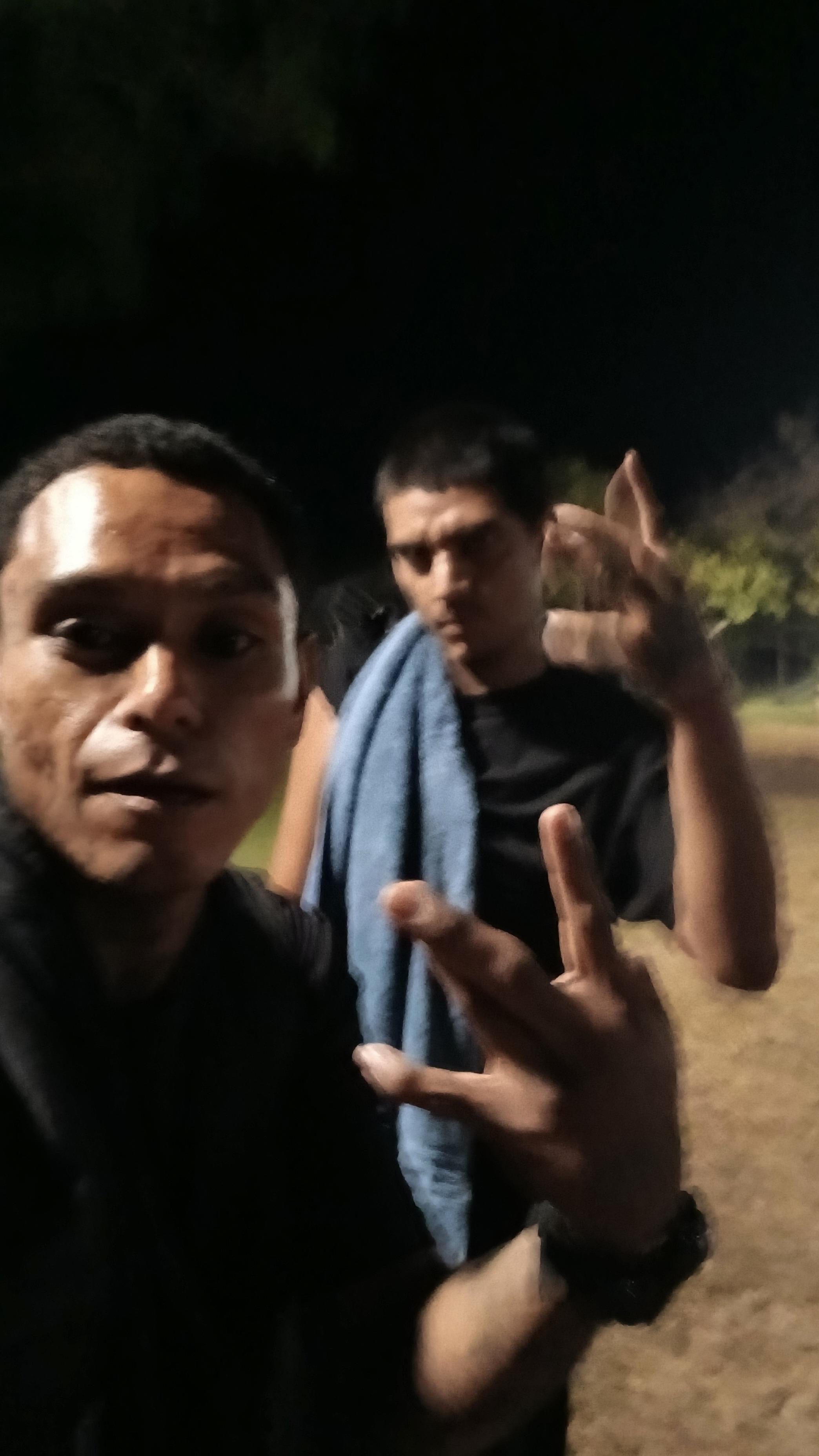 A man taking a selfie with another man