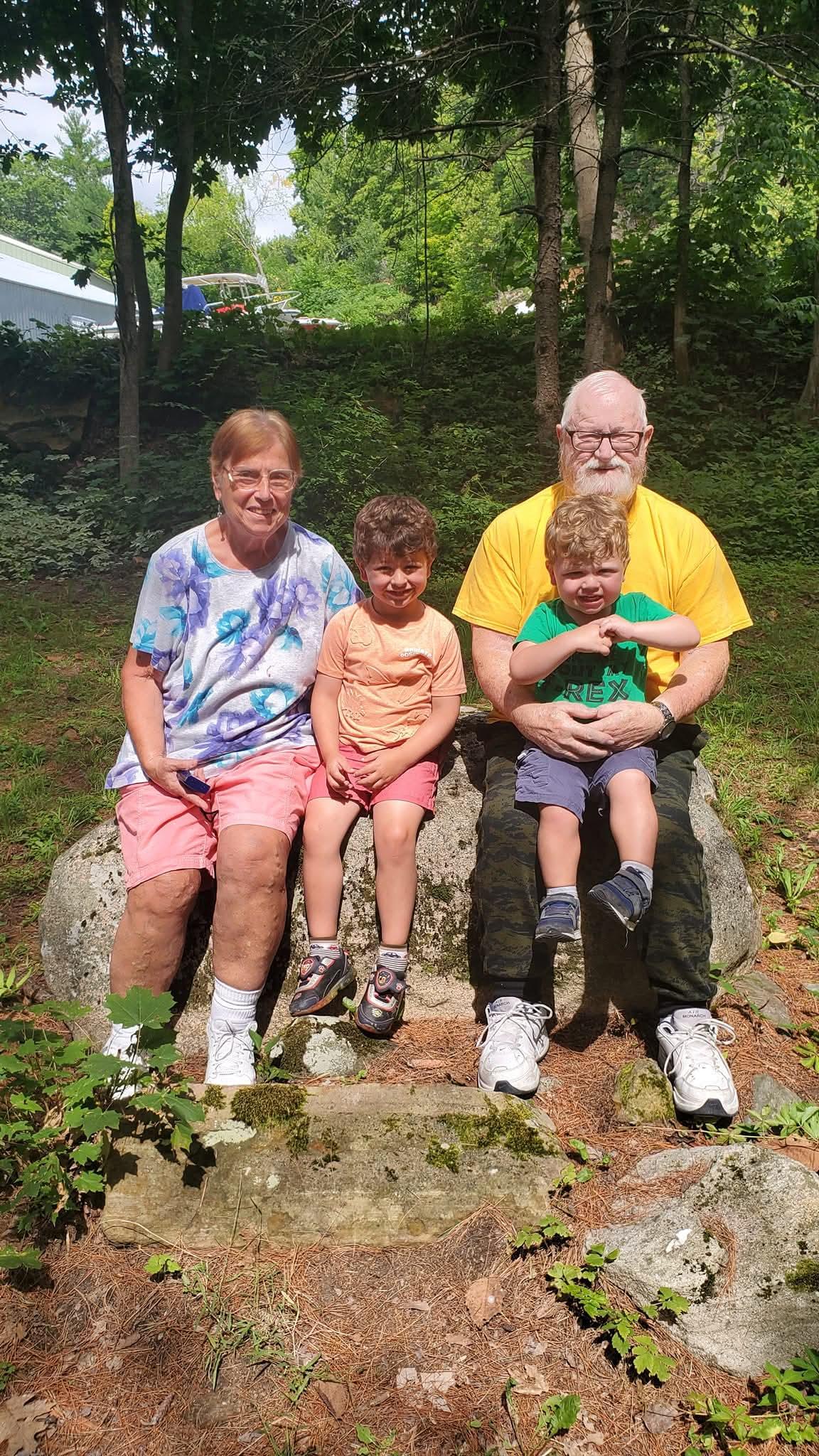 A group of people sitting on a rock