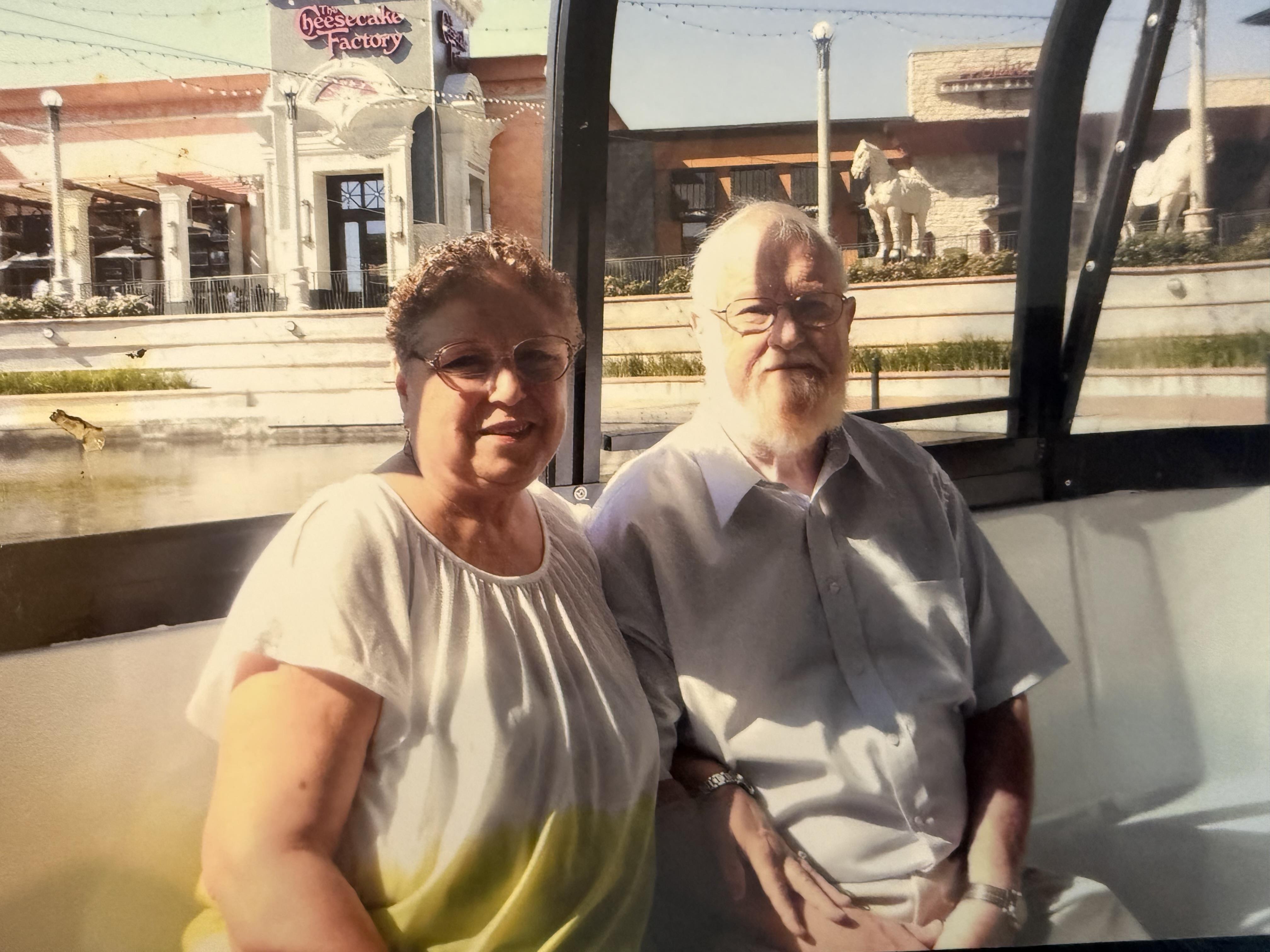 A man and woman sitting on a bus