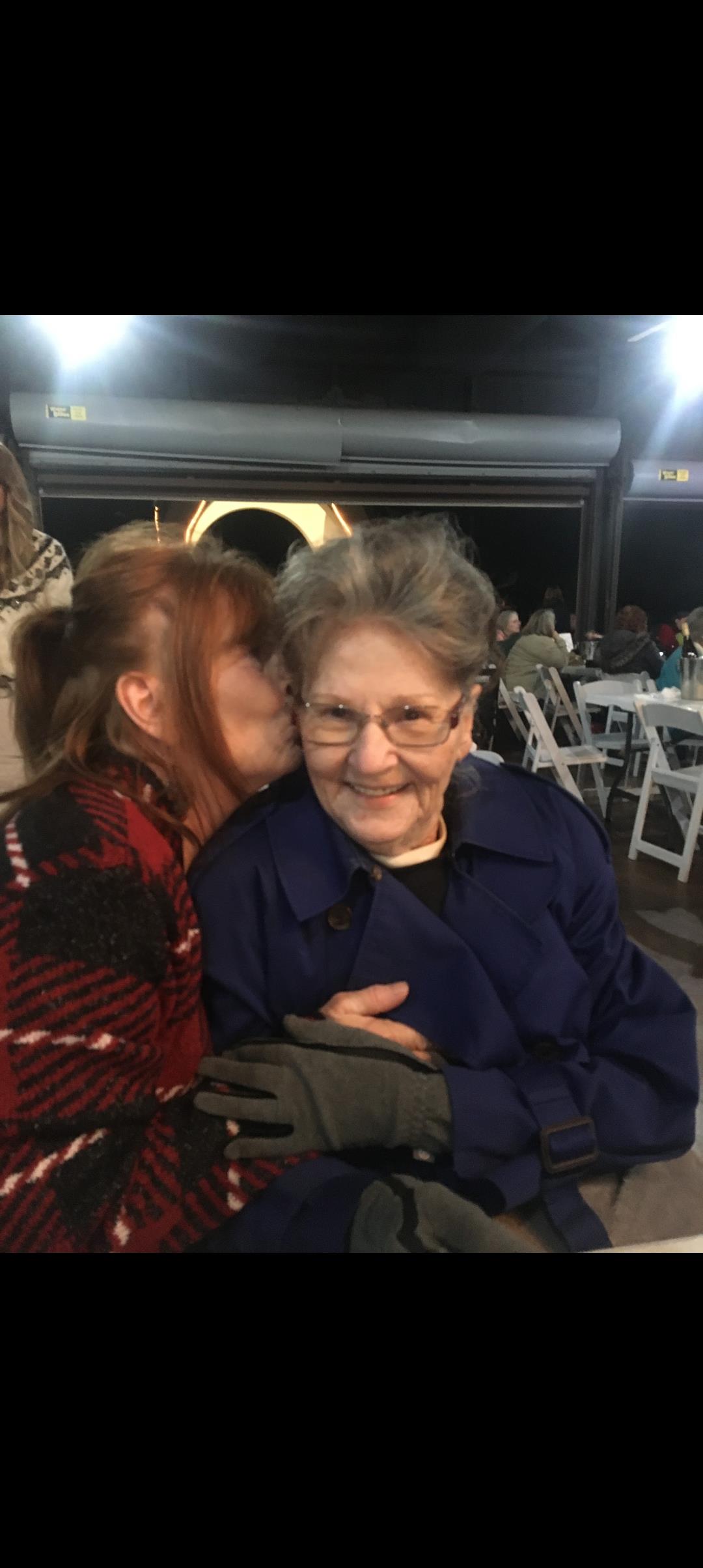 A woman kissing an older woman