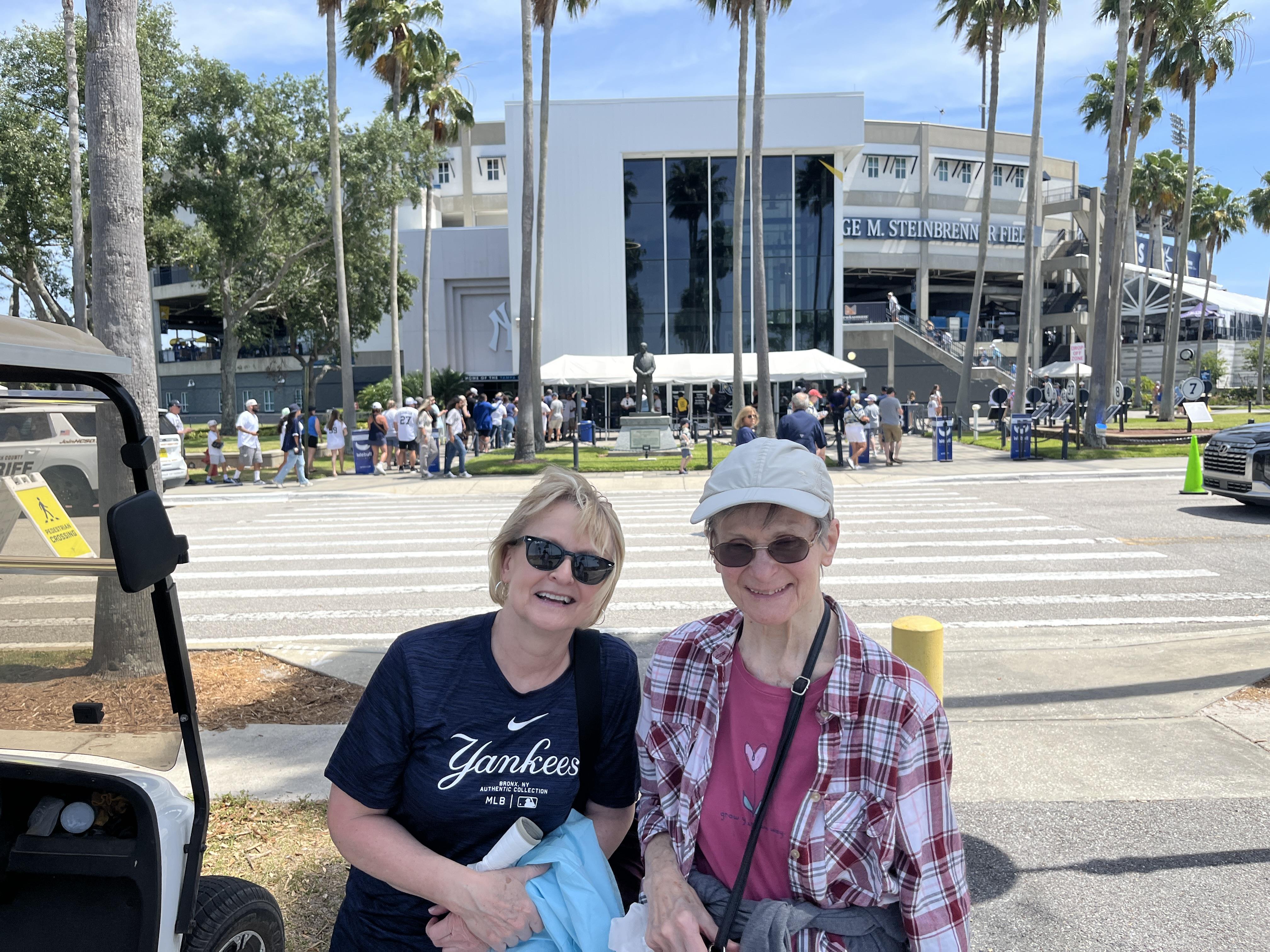 Two women standing in front of a building