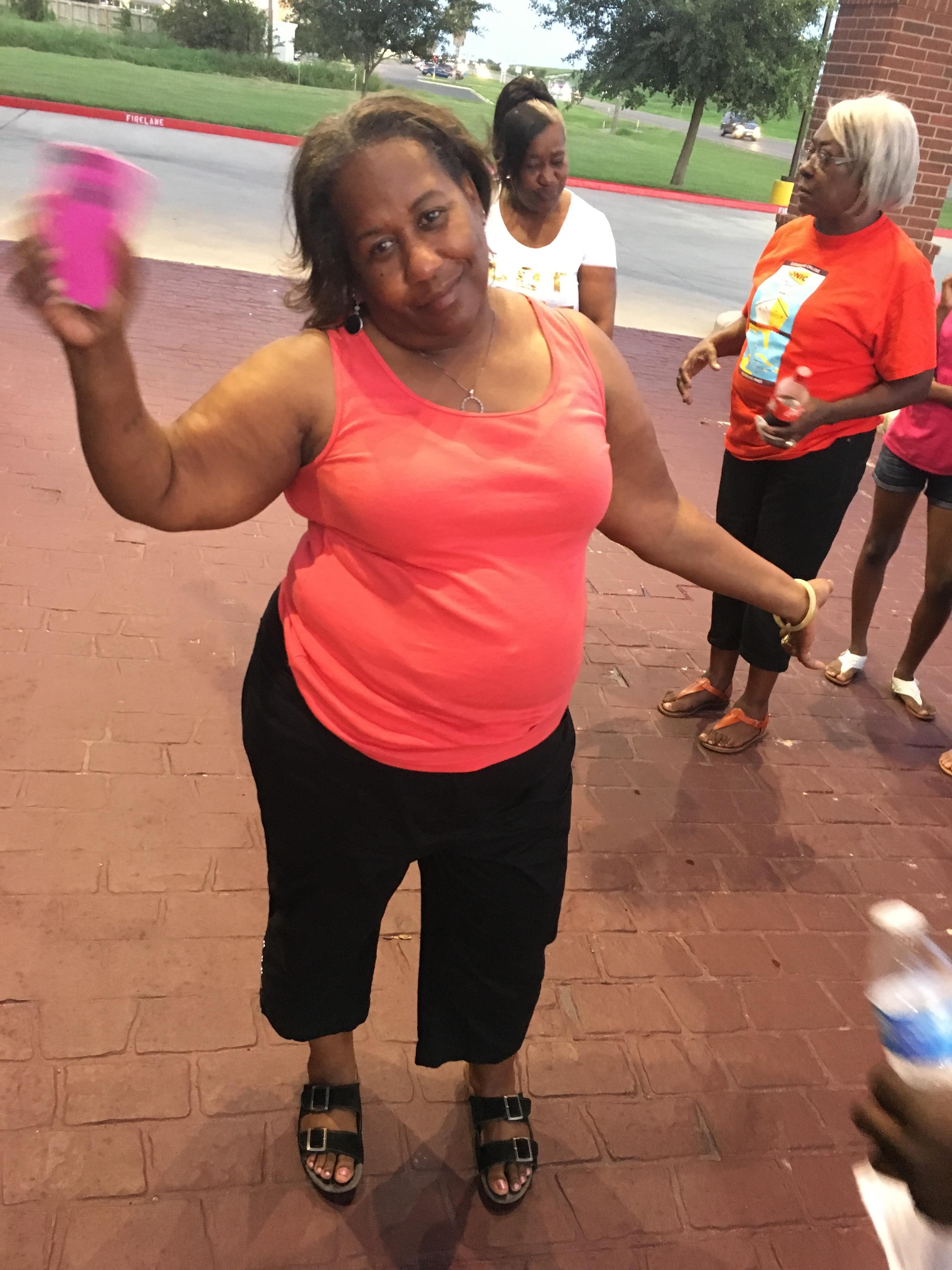 A woman holding a pink object