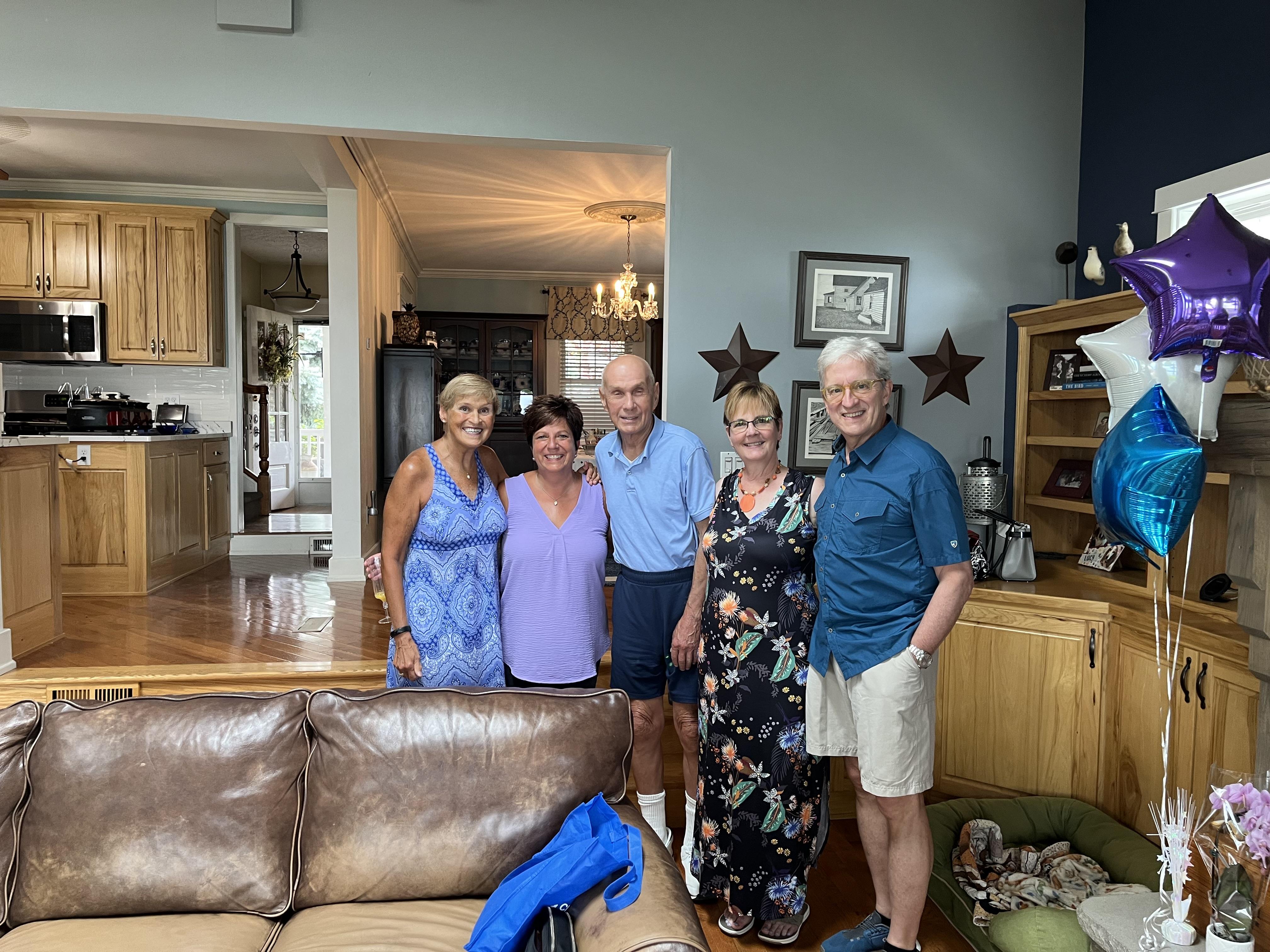 A group of people standing in a living room