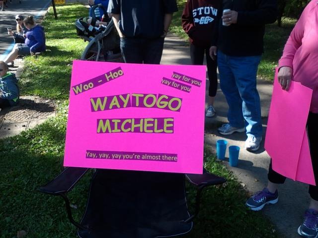 A pink sign with yellow text