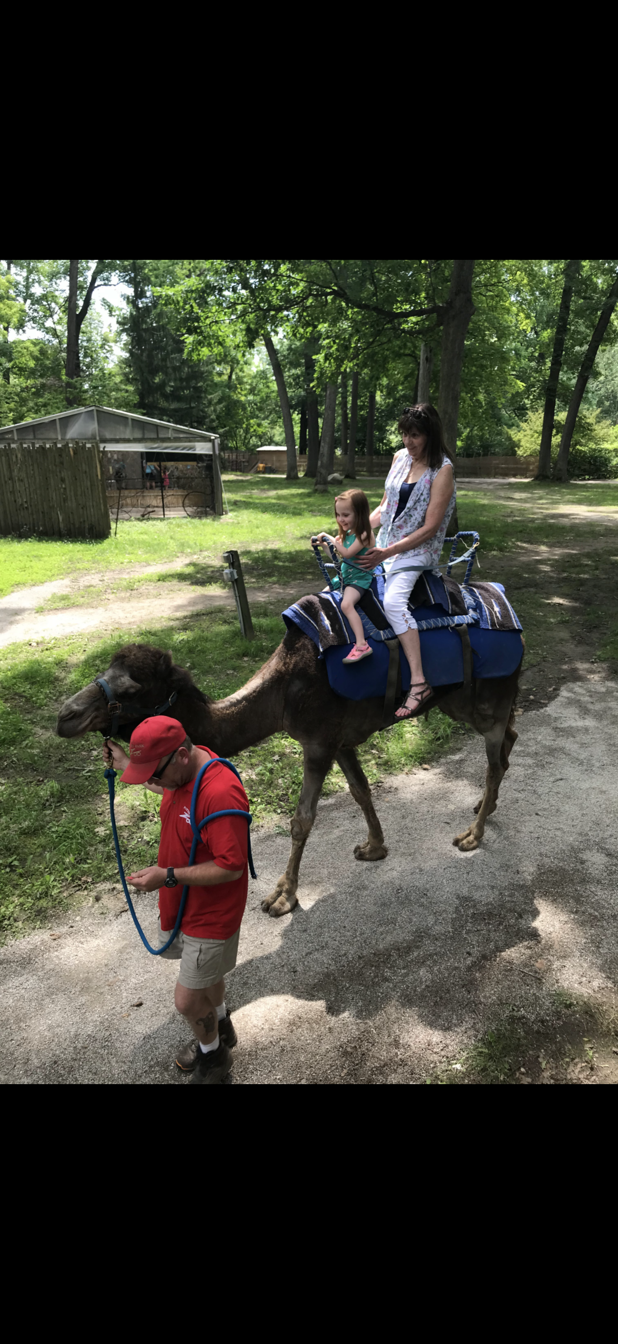 A woman and child riding a camel