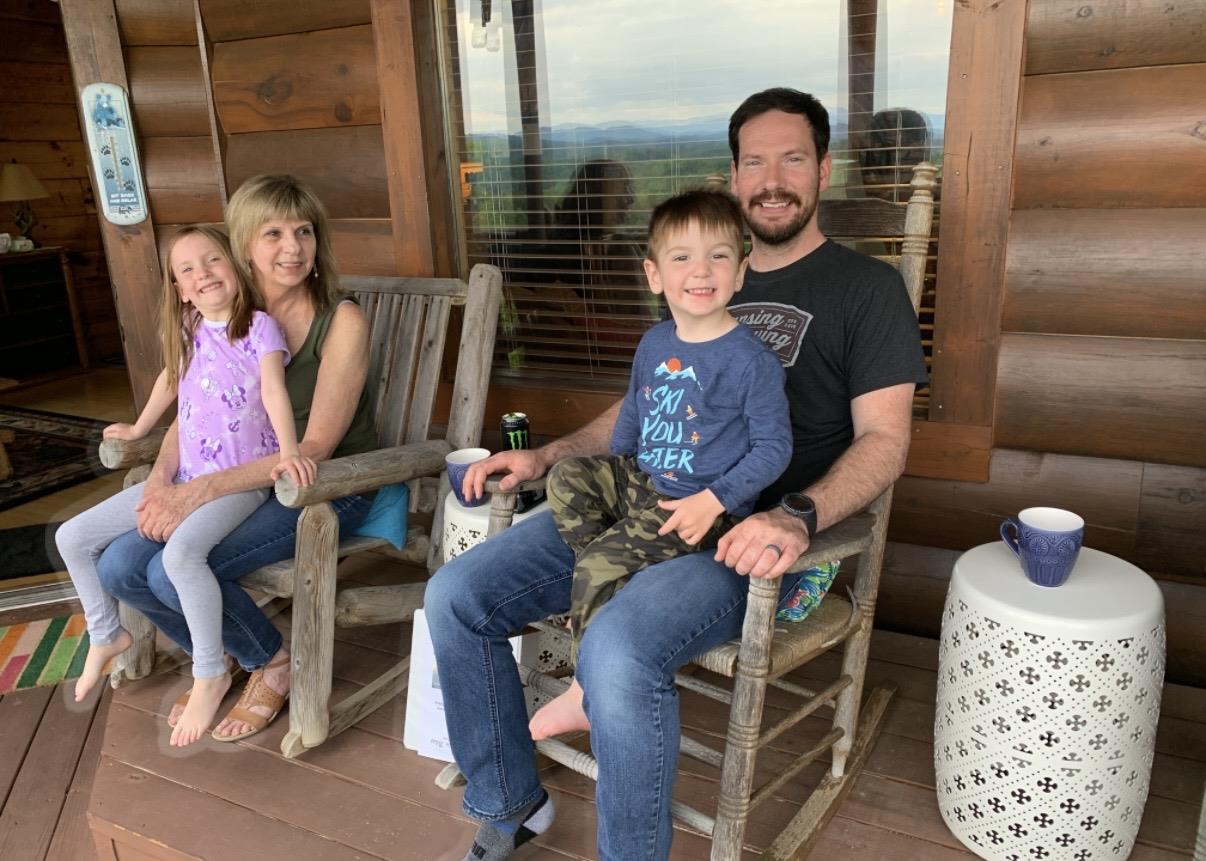 A family sitting in rocking chairs