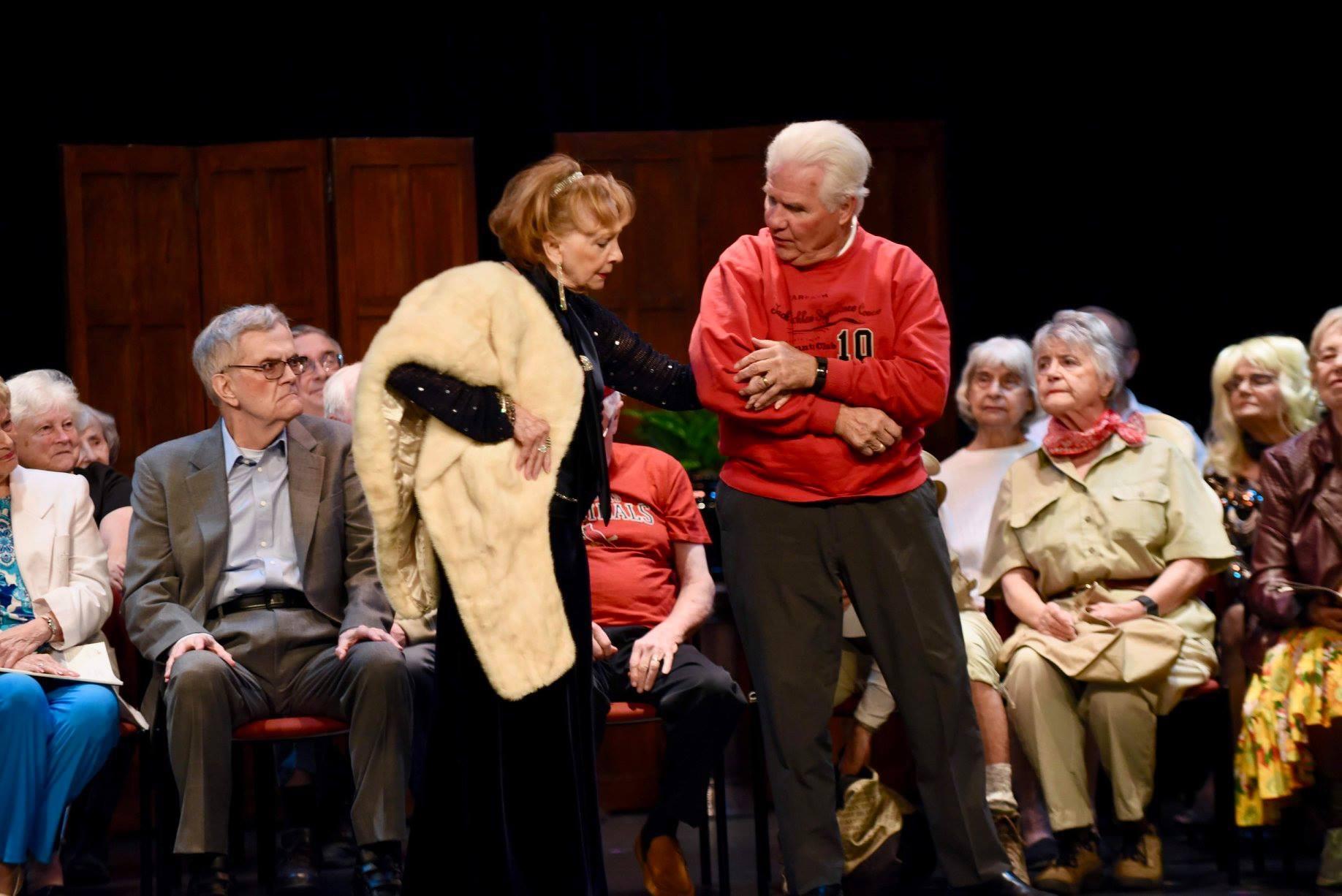 A man and woman standing on a stage