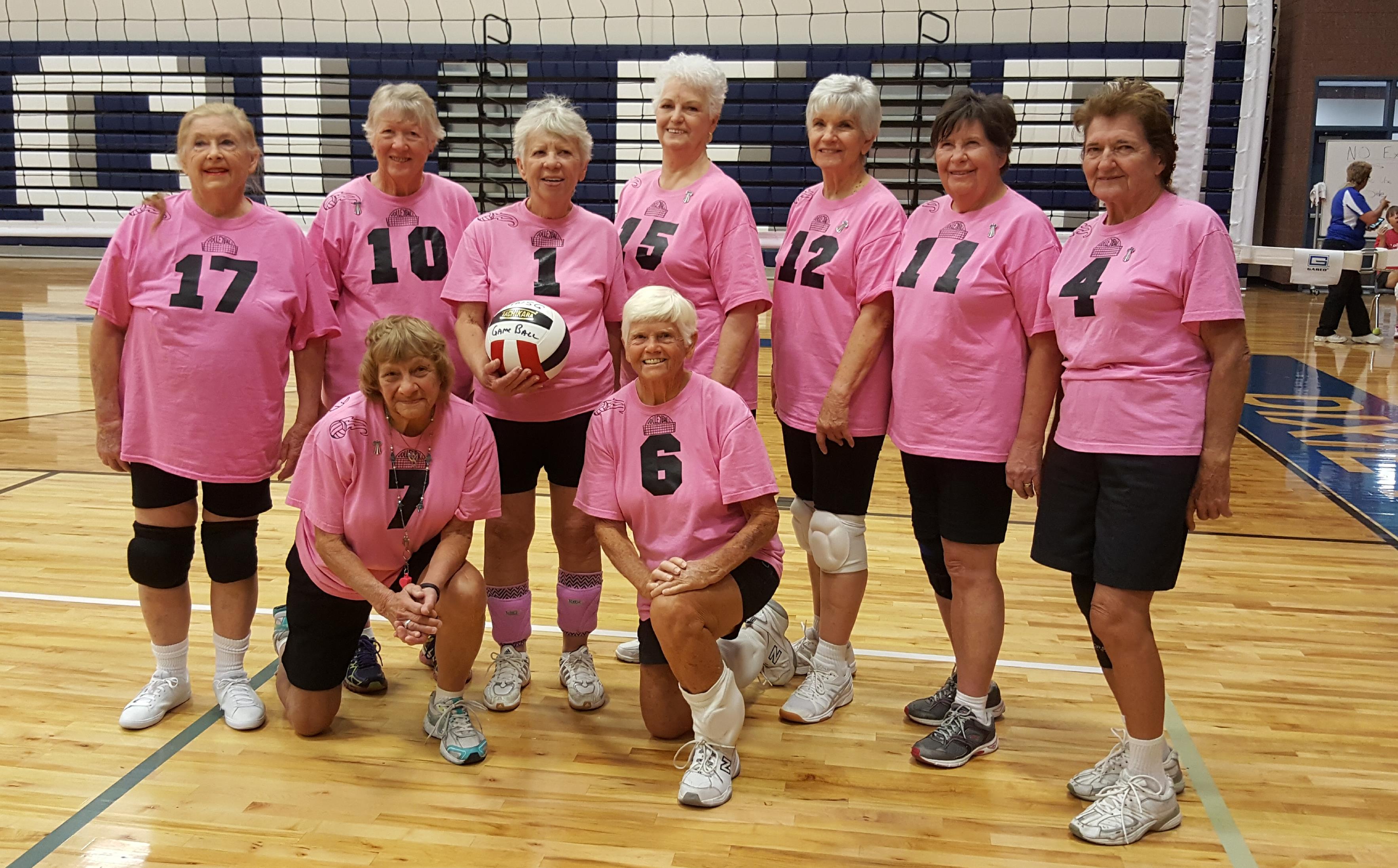 A group of women wearing pink shirts