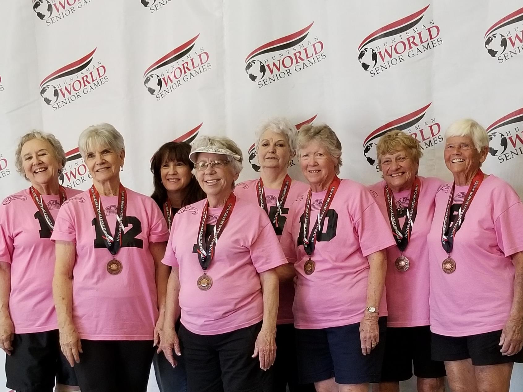 A group of women wearing medals