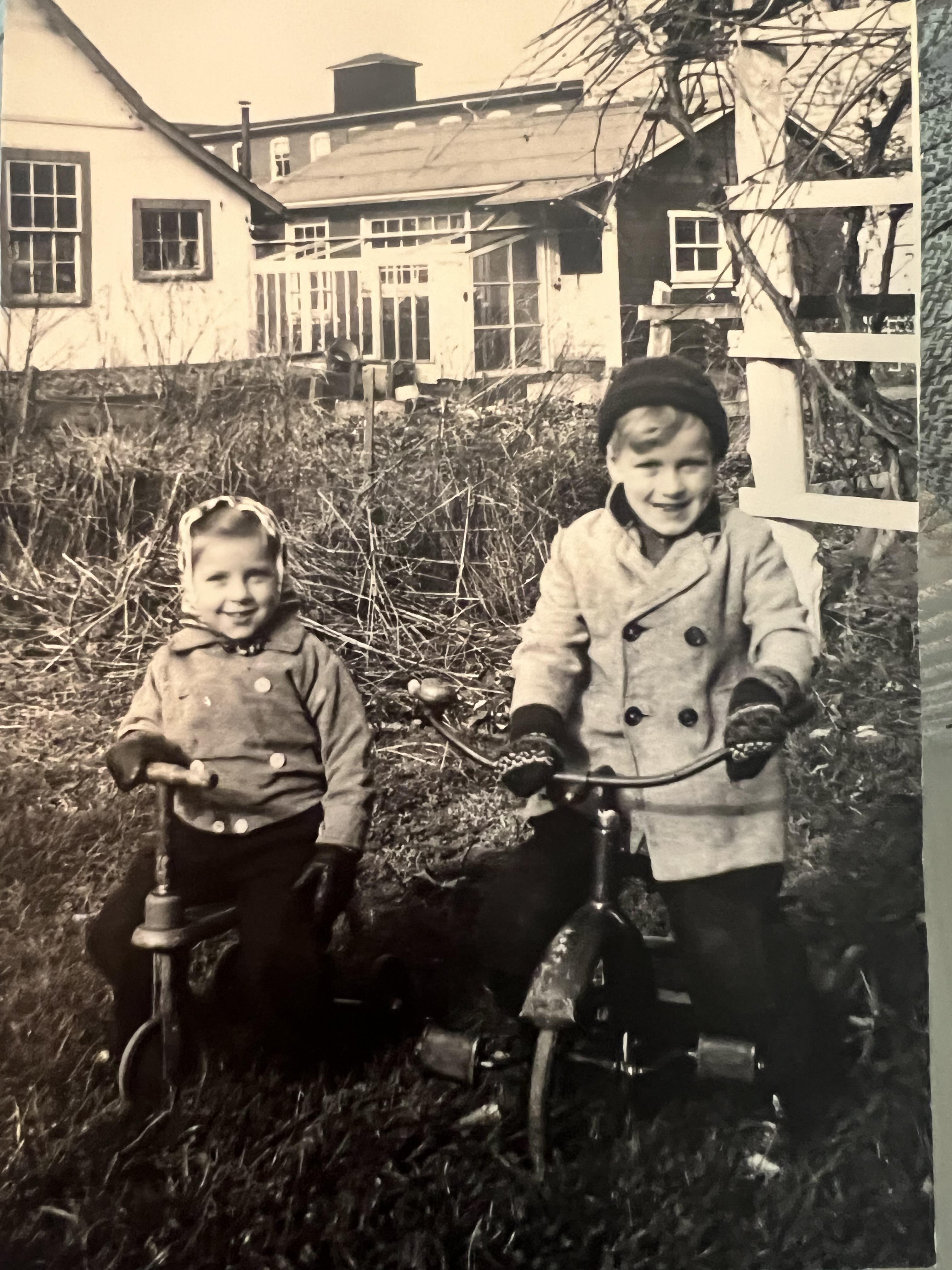 A couple of children on a tricycle