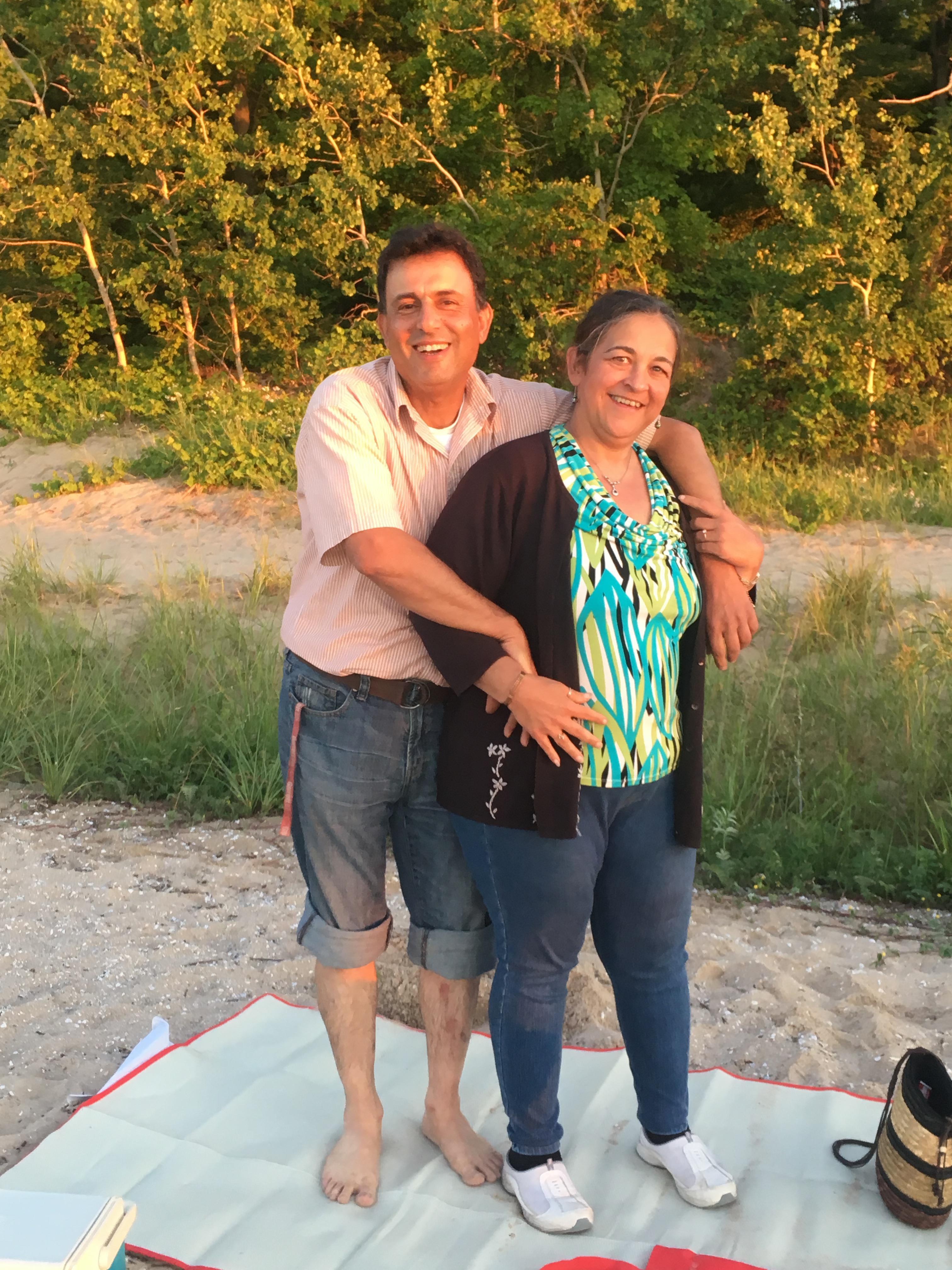 A man and woman standing on a blanket