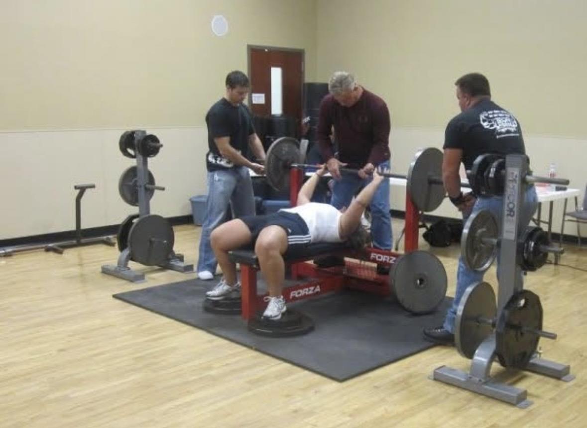 A group of men lifting weights